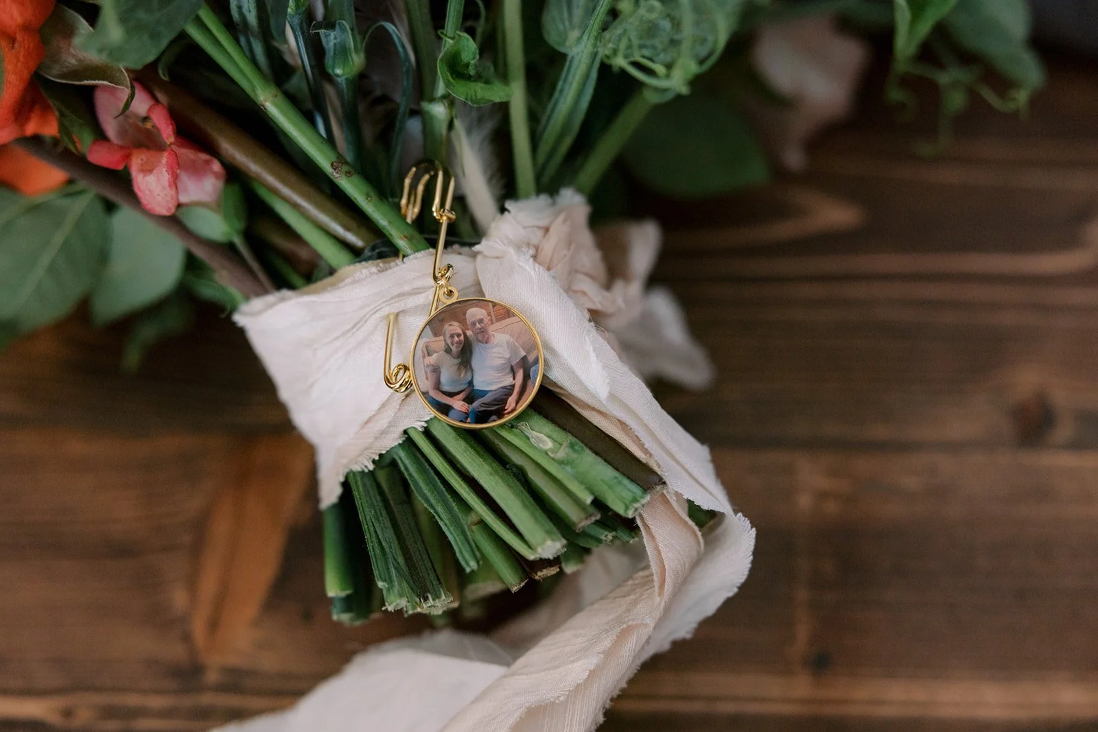 keepsake pinned to the bridal bouquet