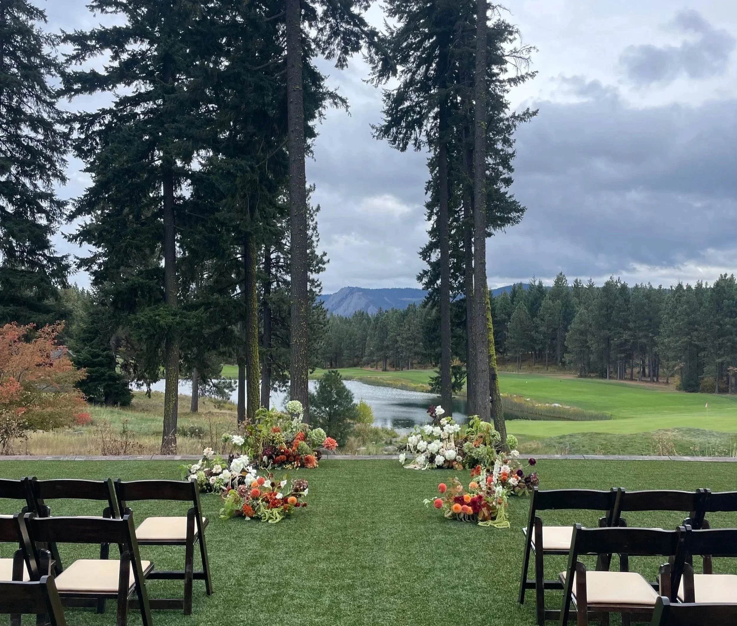 Autumnal floral ground arch using seasonal, local blooms and native fall foliage to create a modern, romantic, dynamic altar design, like stepping into a little garden to say your vows.