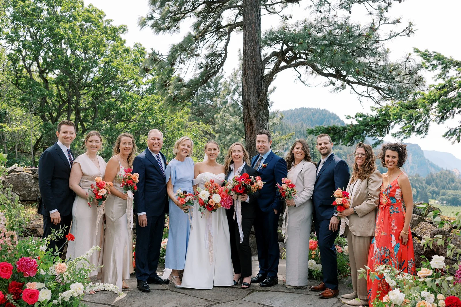 wedding party and family in front of the  ceremony flowers 