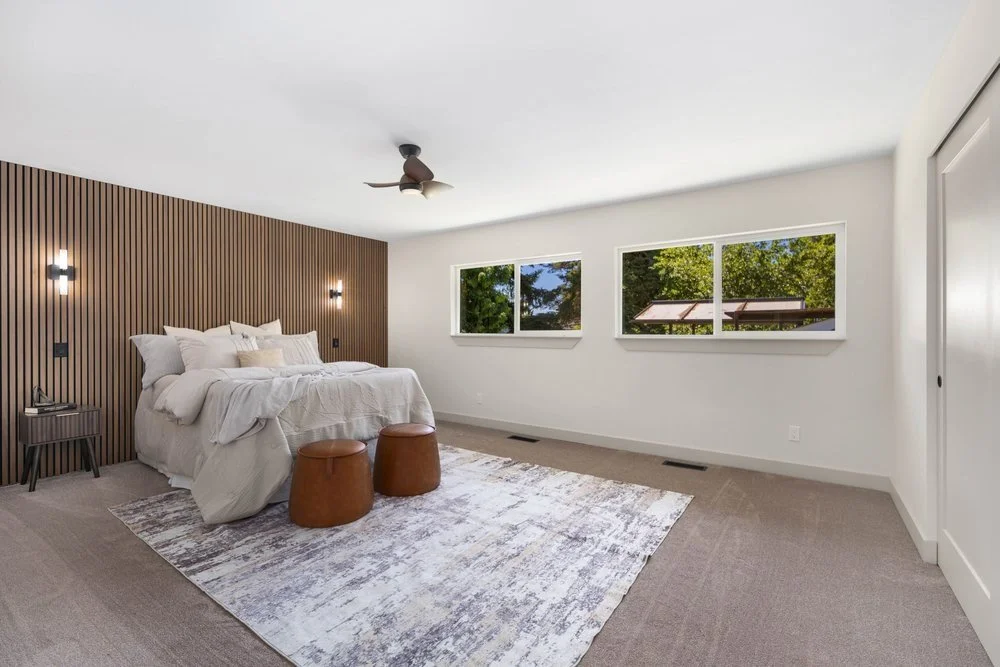Scenic Hill Flip: Primary bedroom with custom wood wall feature