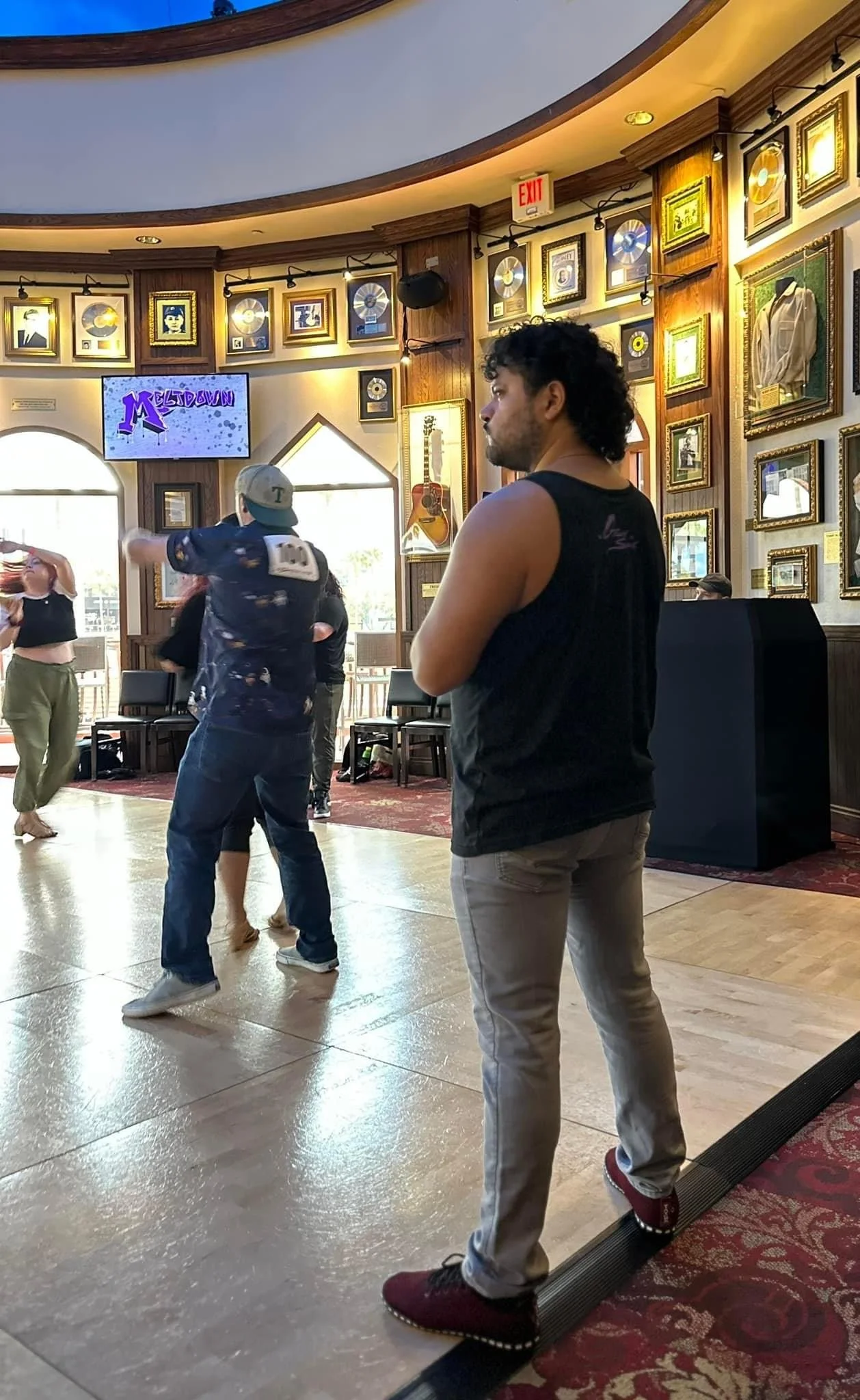 Derek watching and judging auditions on the edge of the dance floor.