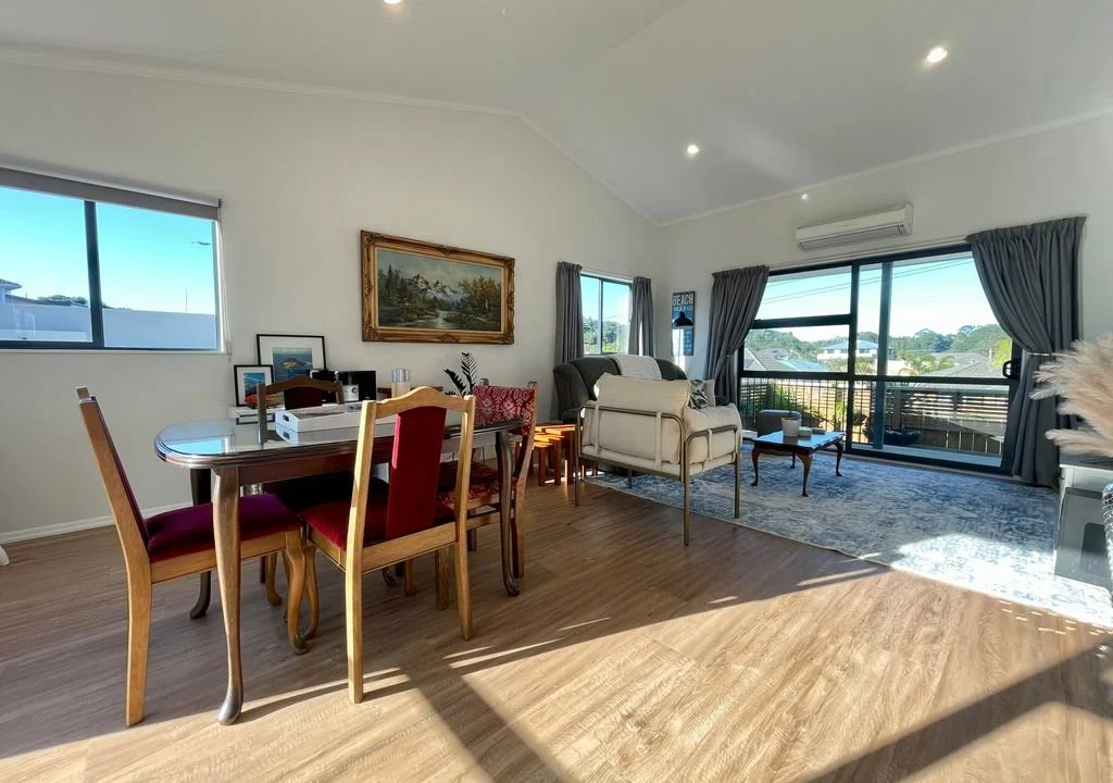 Open plan living area with access to deck