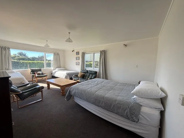 downstairs big bedroom - queen, 2 x king singles + single rollaway (sleeps 5)
