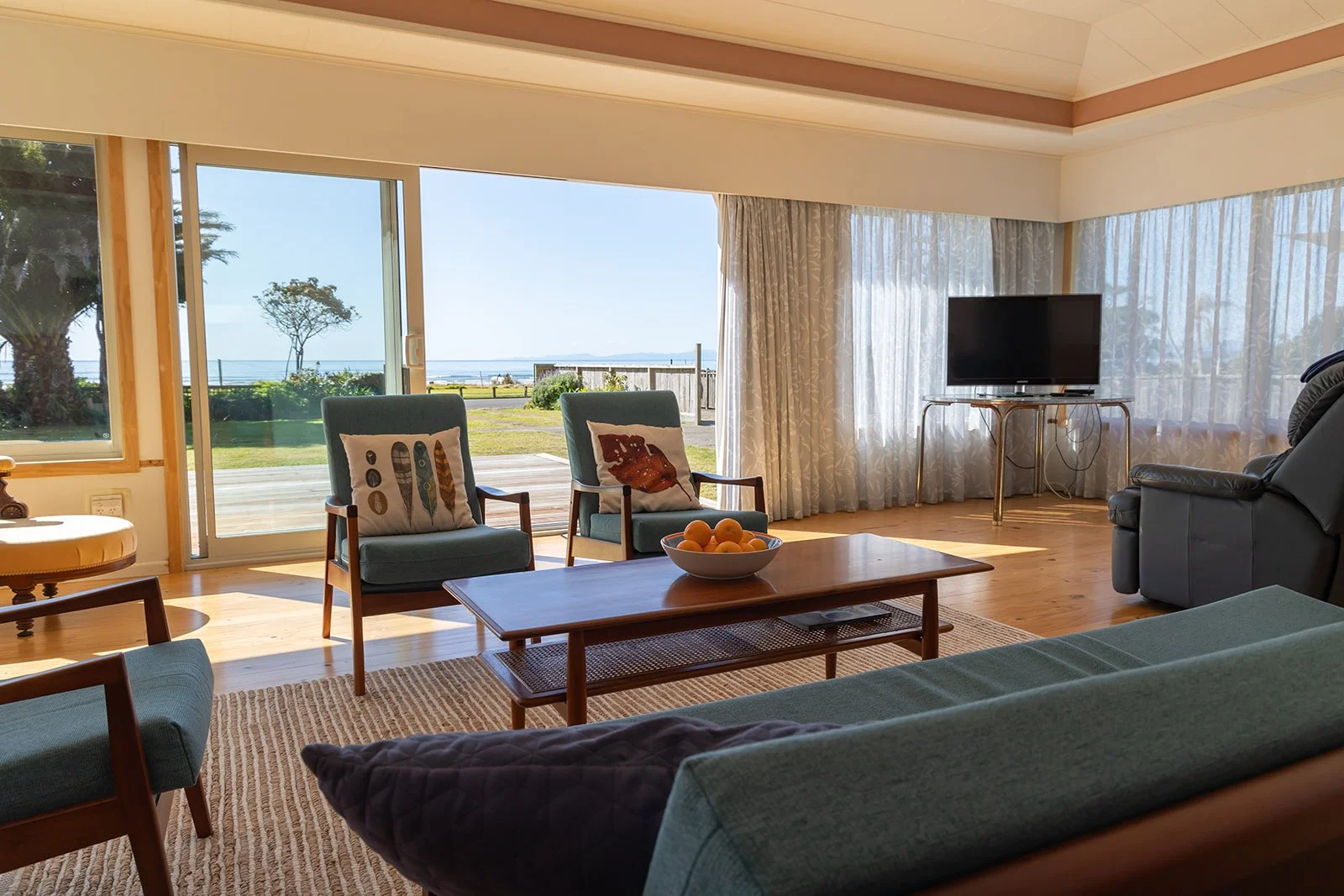 Lounge with sea views & outdoor access to deck