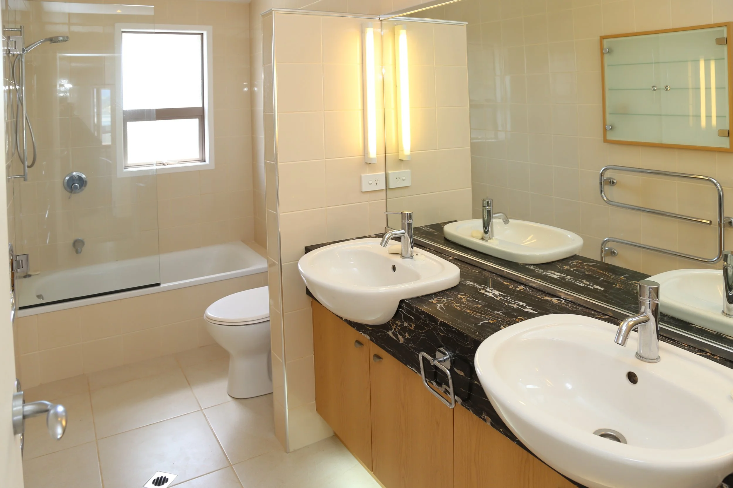 2nd bathroom upstairs with shower over bath, toilet and double basins