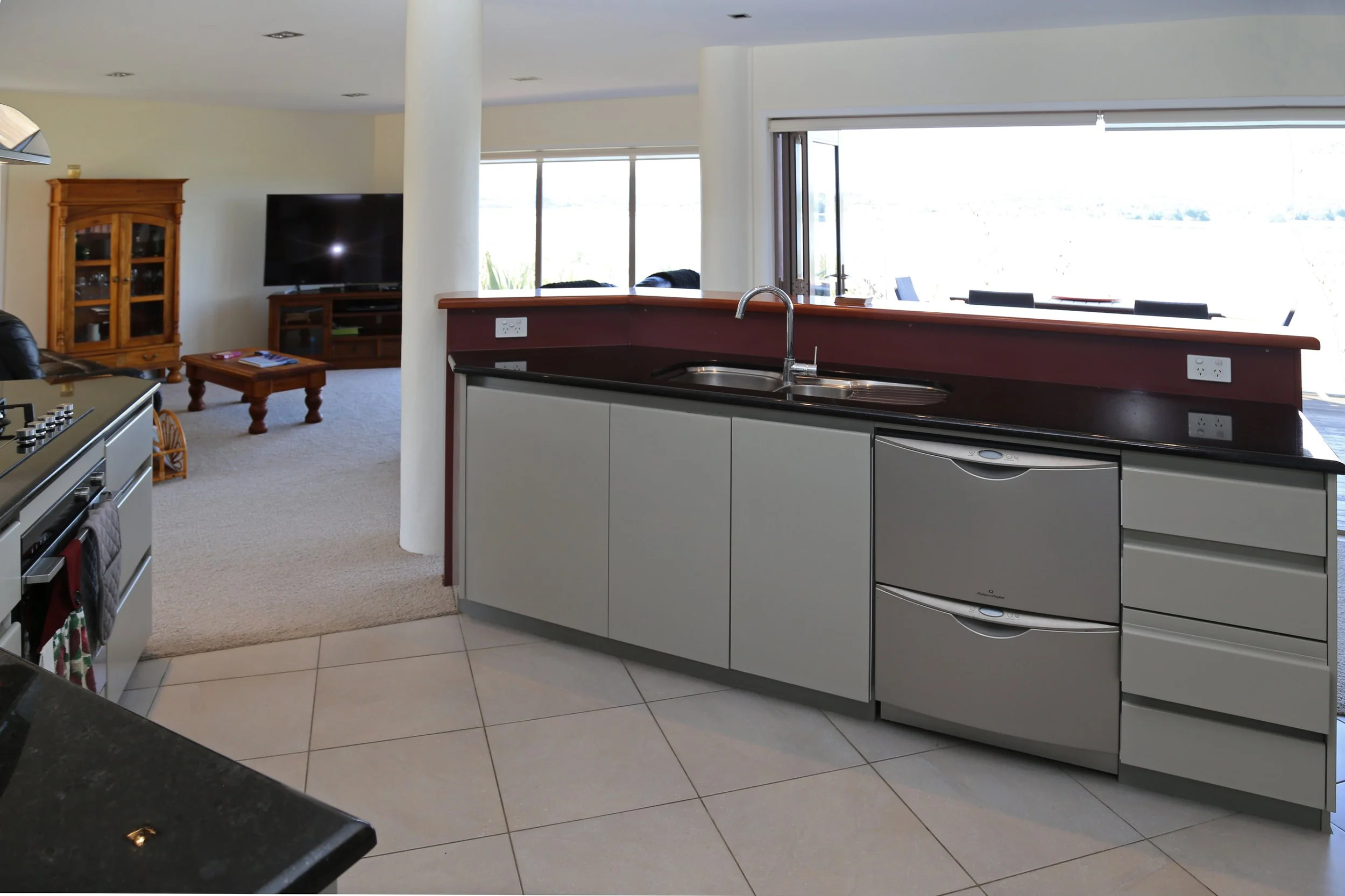 fully equipped kitchen between lounge and dining areas