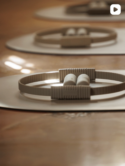 Minimal close up of Pilates ring and accessories resting on a mat, highlighting equipment detail and texture