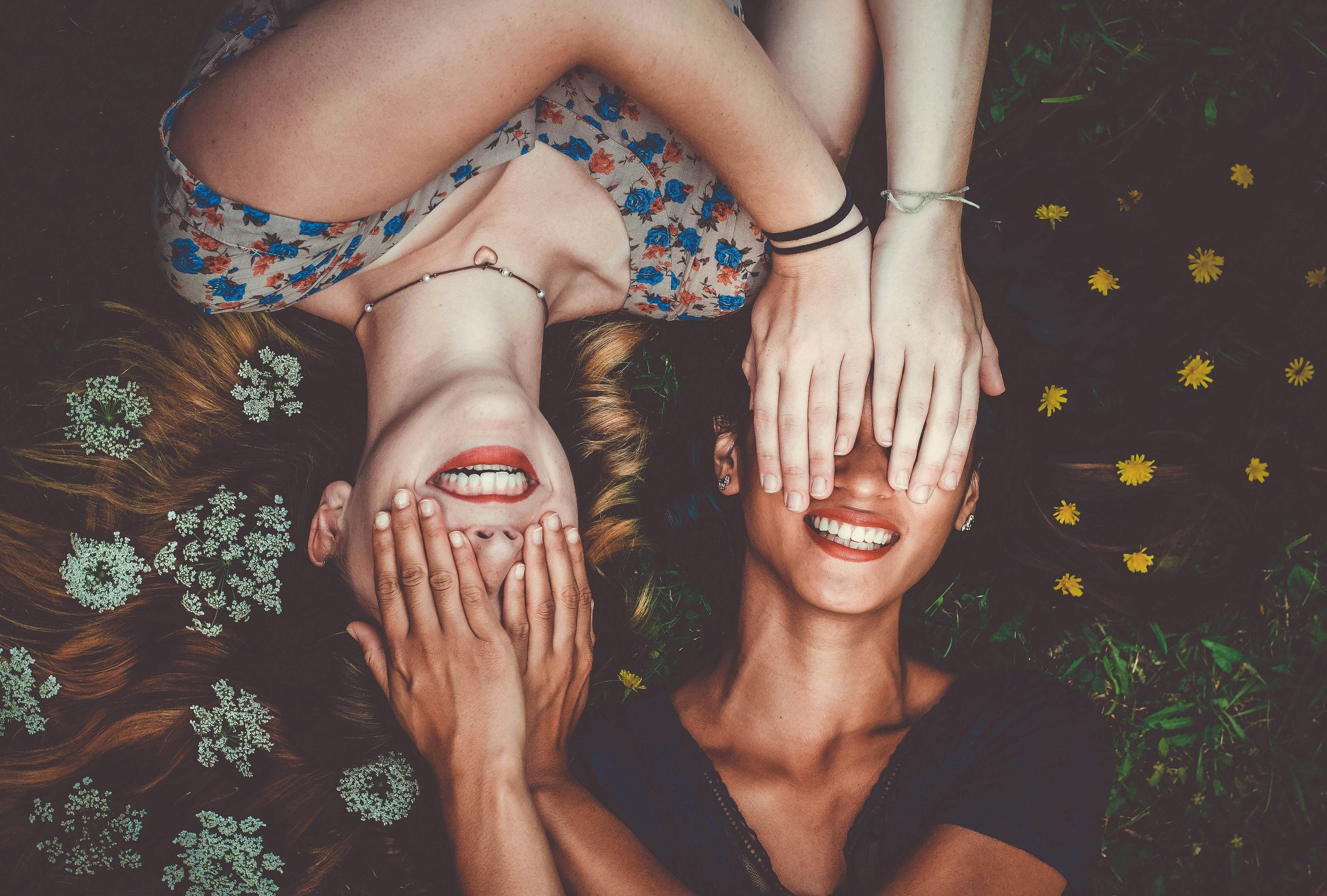 Image of two friends playfully covering each other's eyes