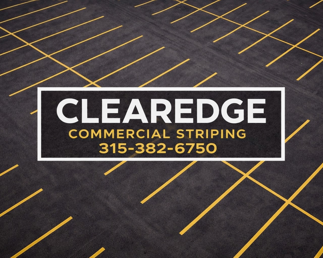 Image of asphalt parking lot with yellow painted parking spots and stalls. With Clearedge commerical striping logo in the middle.