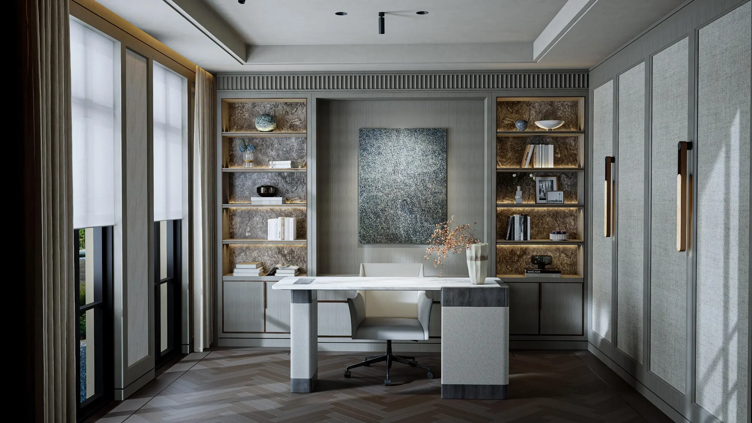 Luxury executive home office in Toronto designed by Claire Design Studio, featuring bespoke floor-to-ceiling library shelving with marble backpanels, a custom stone-top desk, herringbone hardwood floors, and sophisticated modern lighting.