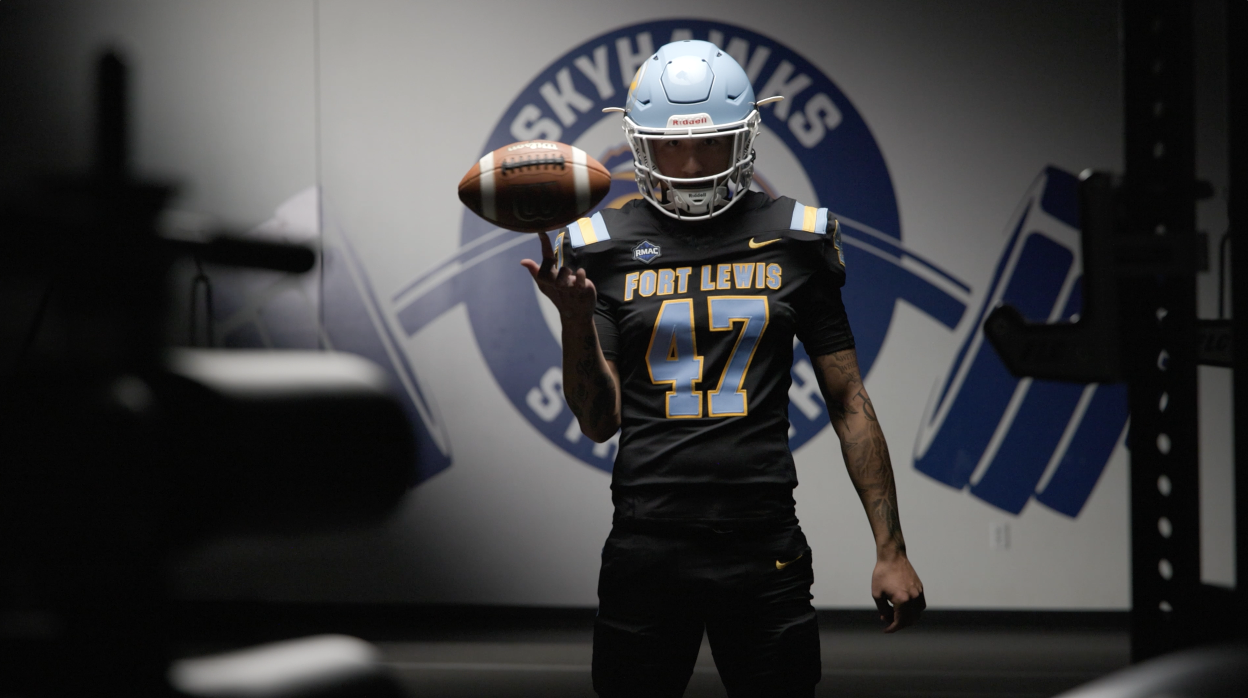 Still image of a Fort Lewis College football player posing for a football season hype video