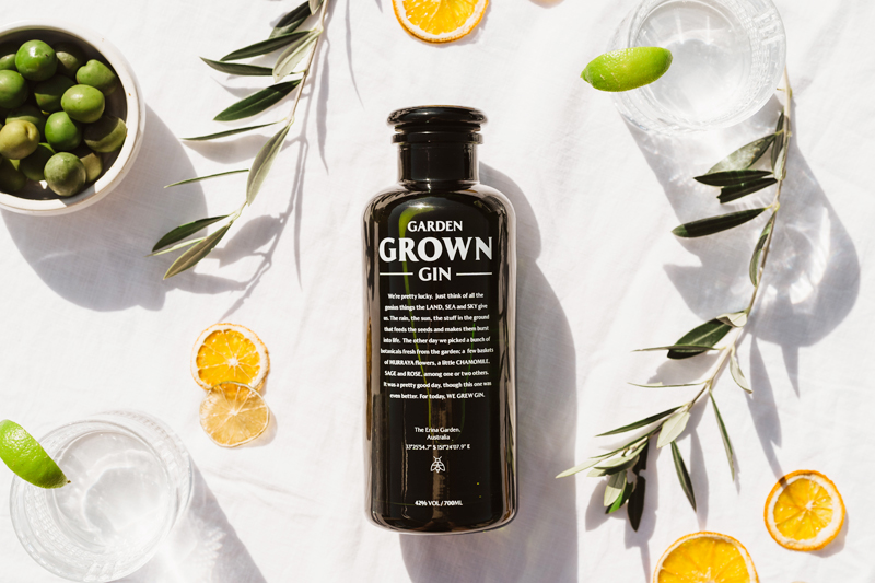 Garden Grown Gin bottle surrounded by dried citrus, lime, and botanicals – Australian craft gin featured by Noble Spirits.