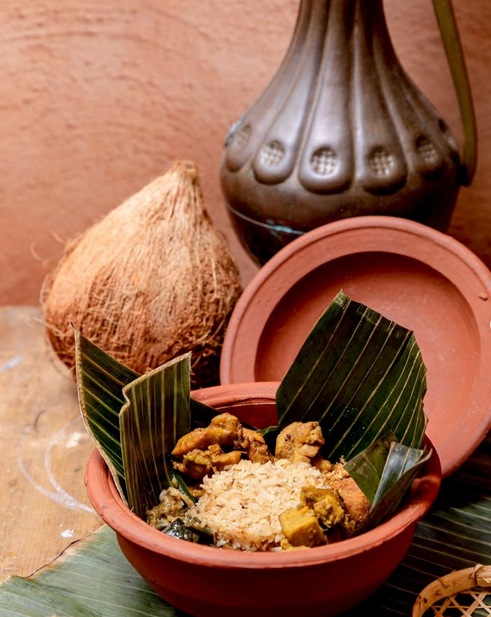 Traditional Sri Lankan rice and curry served in a clay pot with banana leaves and coconut at Kurumba, Surry Hills.