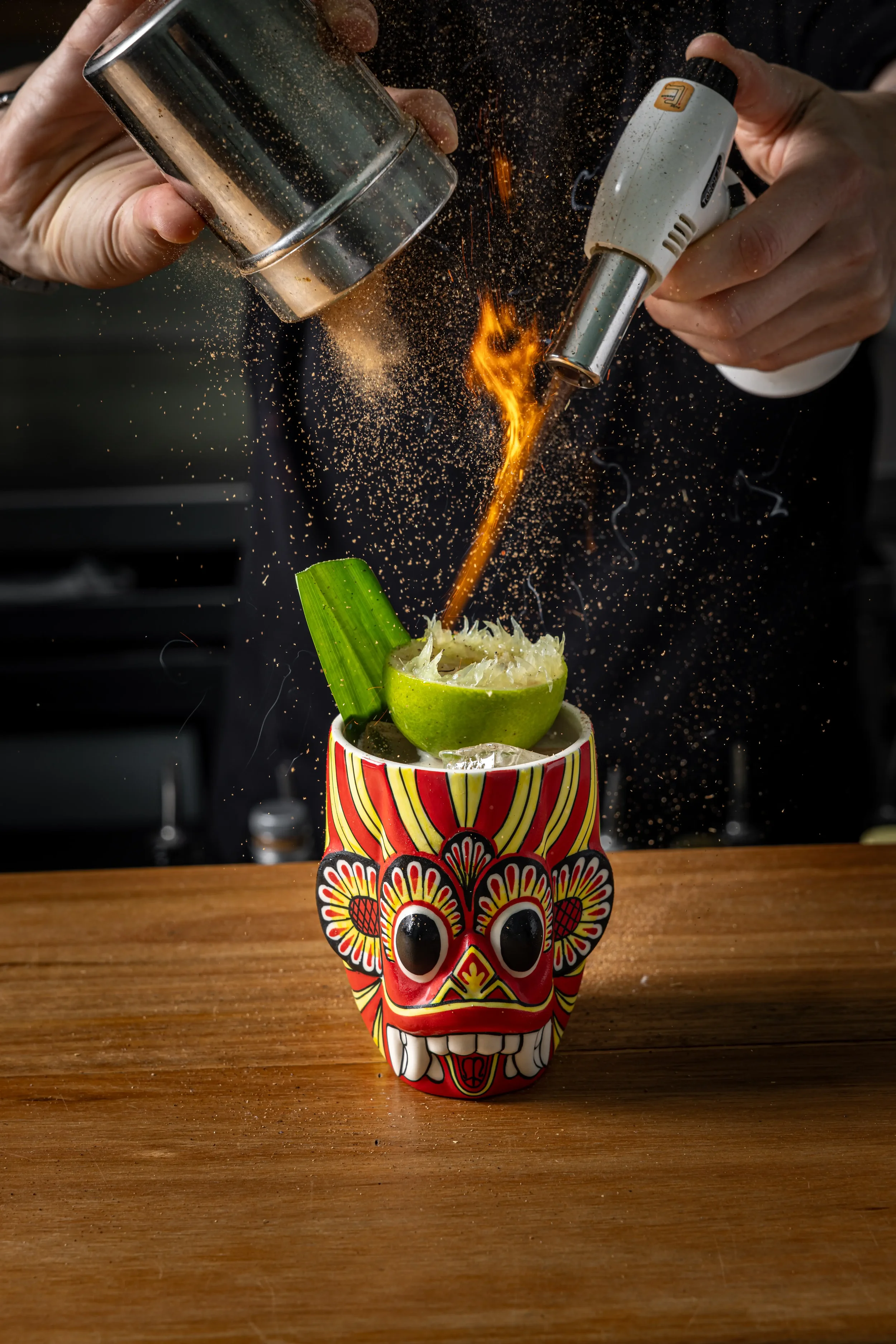 Mask on fire cocktail with plantation pineapple, ginger, whey, pandan finished with a cinnamon fire show by Mindset Spirits