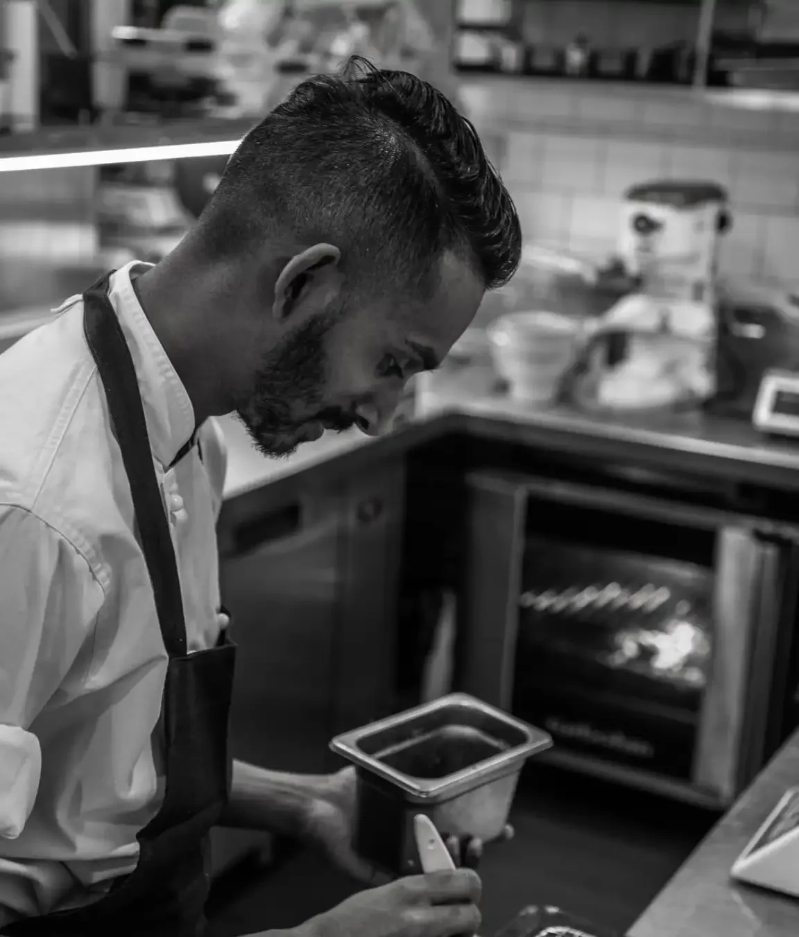 Travin De Hoedt, owner and chef of Kurumba, in the kitchen preparing modern Sri Lankan cuisine in Surry Hills.