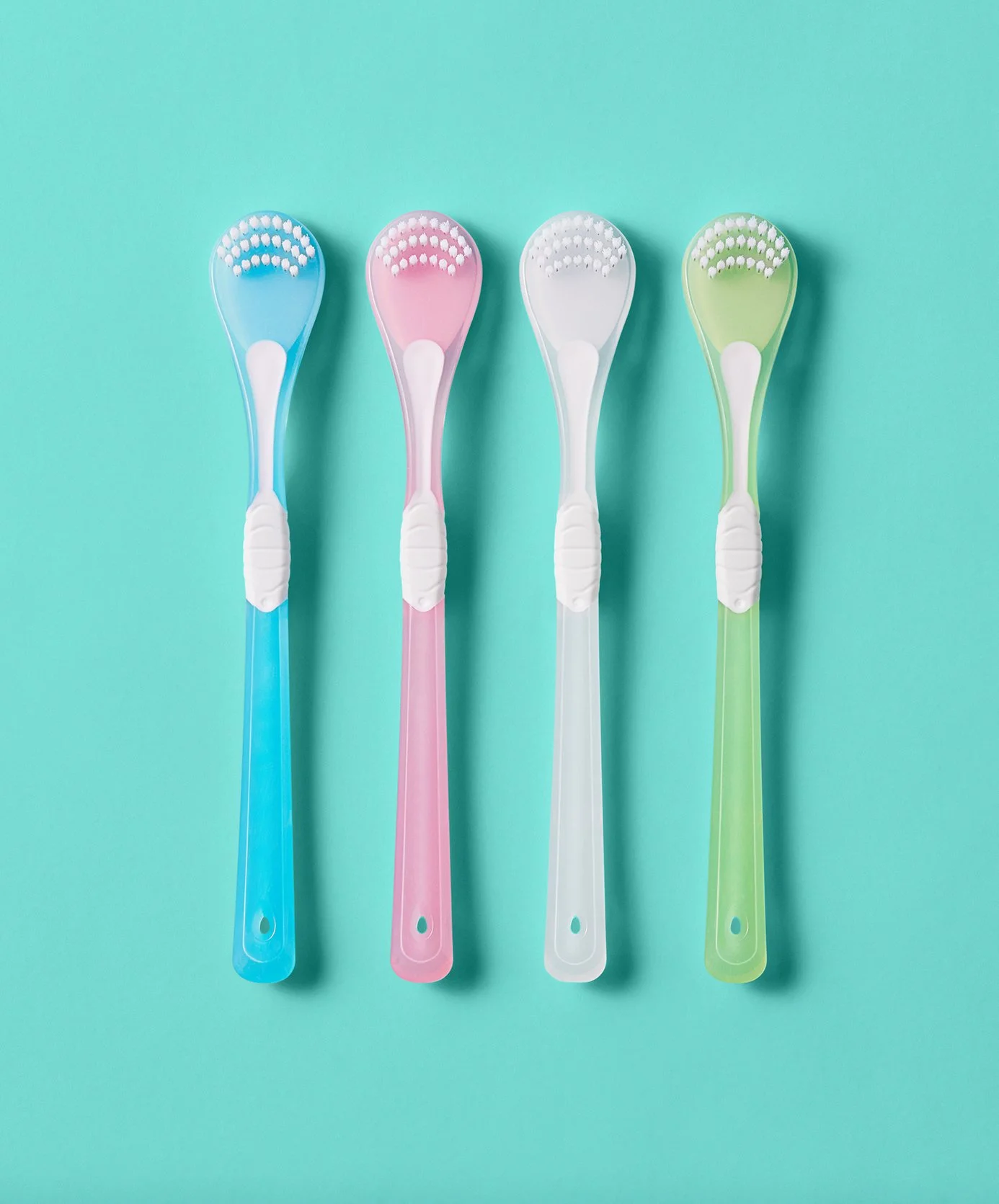 Four colorful manicure tools arranged in a row on a blue background.