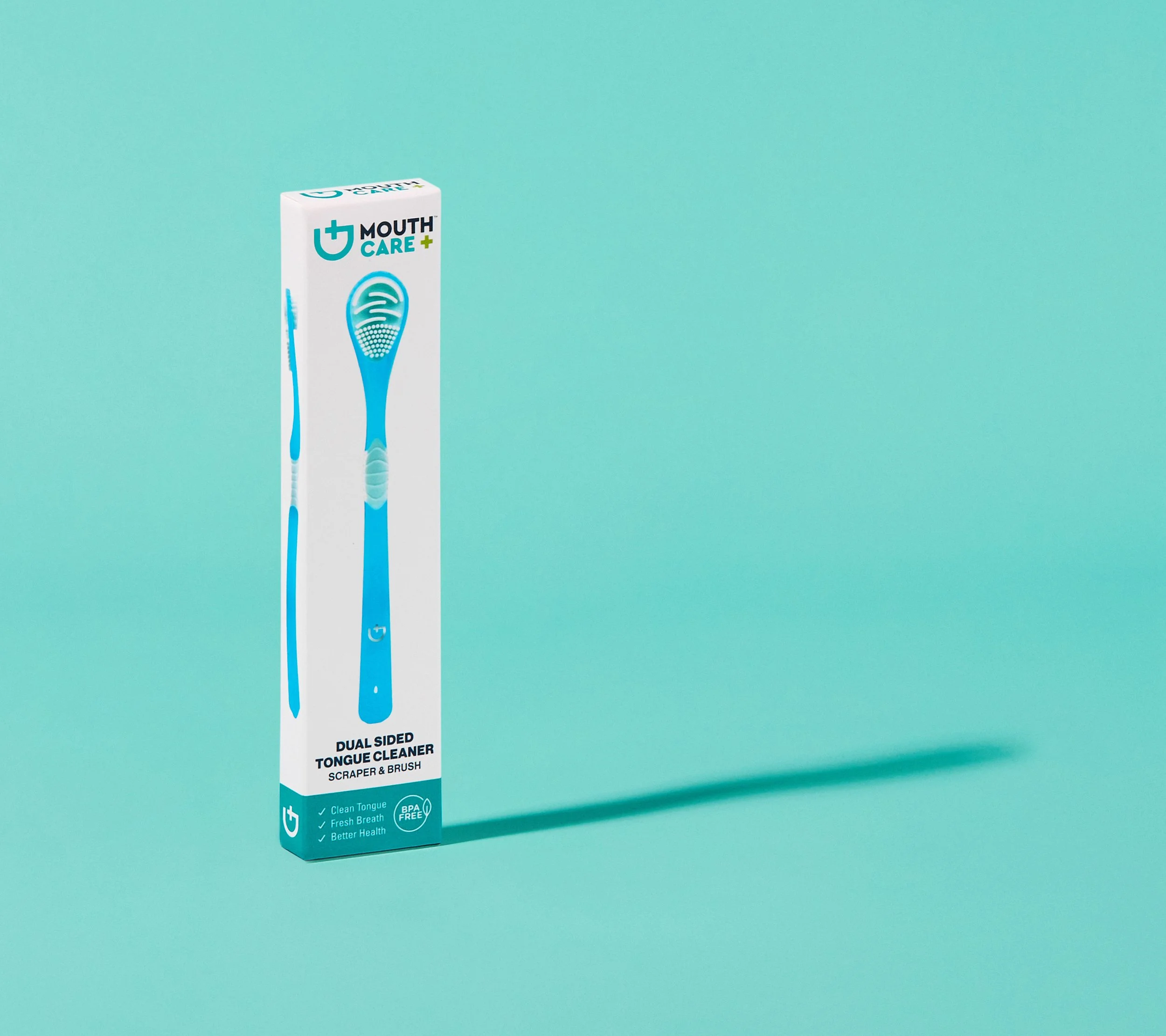 Box of Mouth Care dual-sided tongue cleaner with scraper and brush, standing on a light blue background.