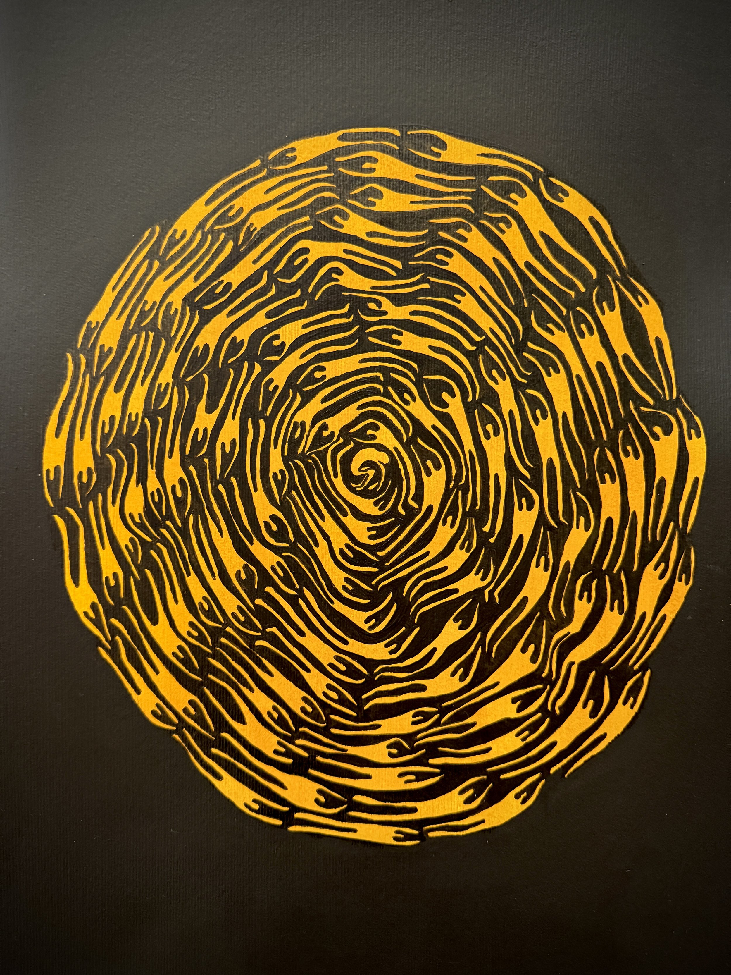 Yellow and black stylized depiction of a tree cross-section showing growth rings.