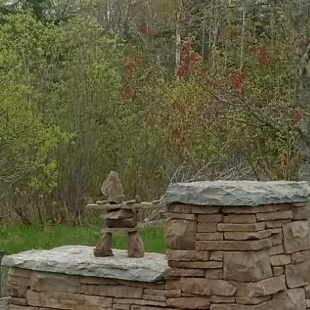 Geometric drawing of an outline square with sections divided by vertical, horizontal, and half circle lines.