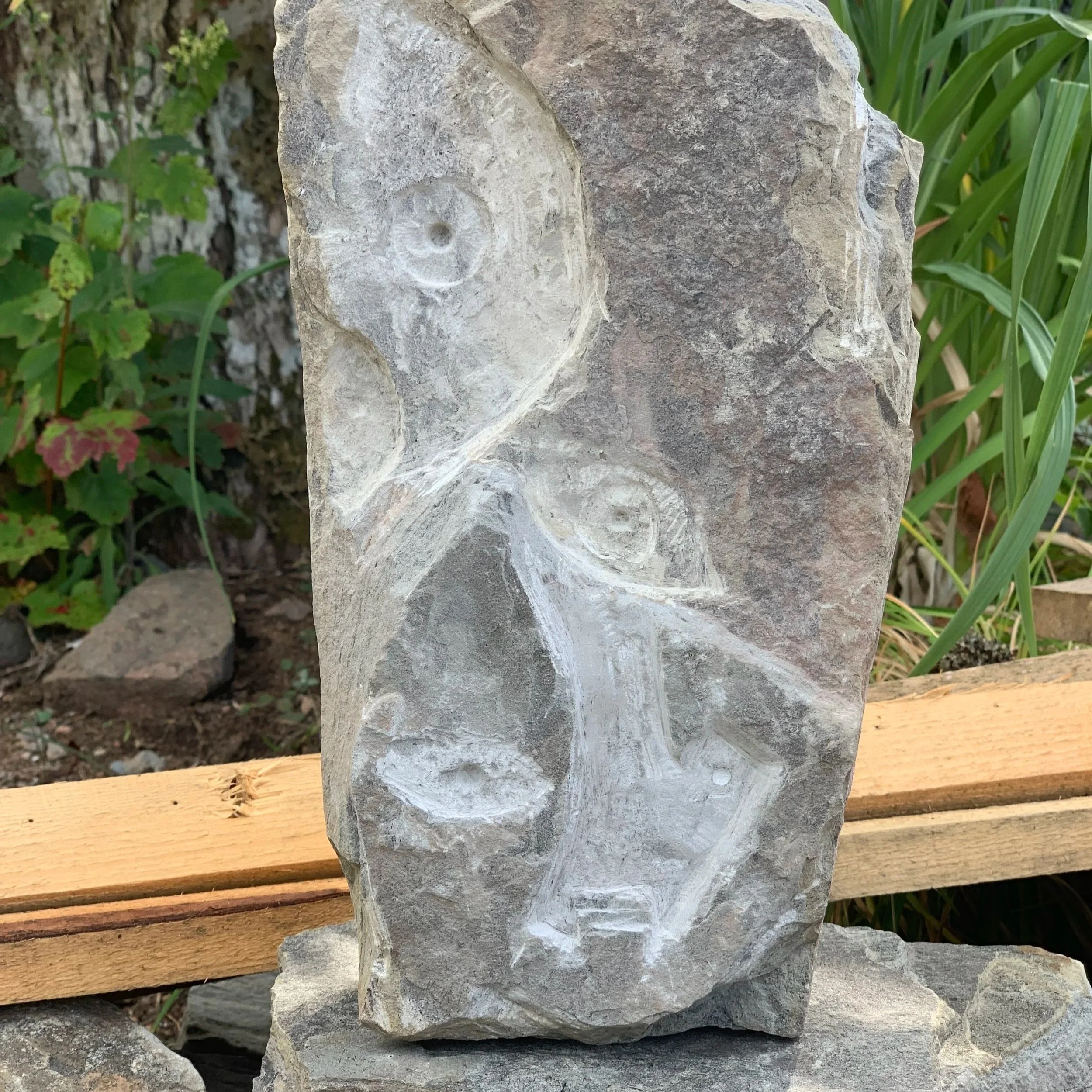 Geometric drawing of an outline square with sections divided by vertical, horizontal, and circle lines.