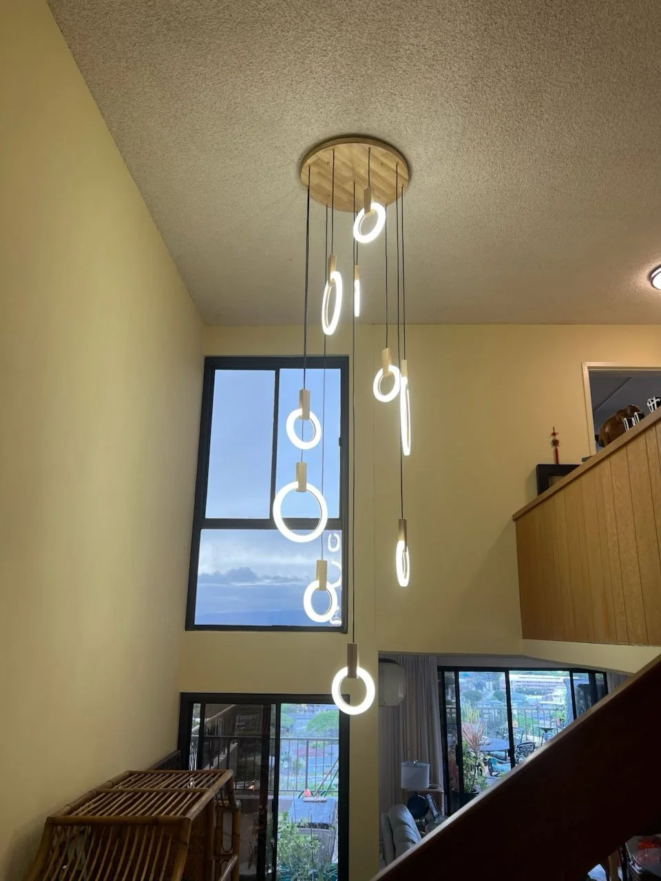 Installed feature chandelier over high ceiling living area