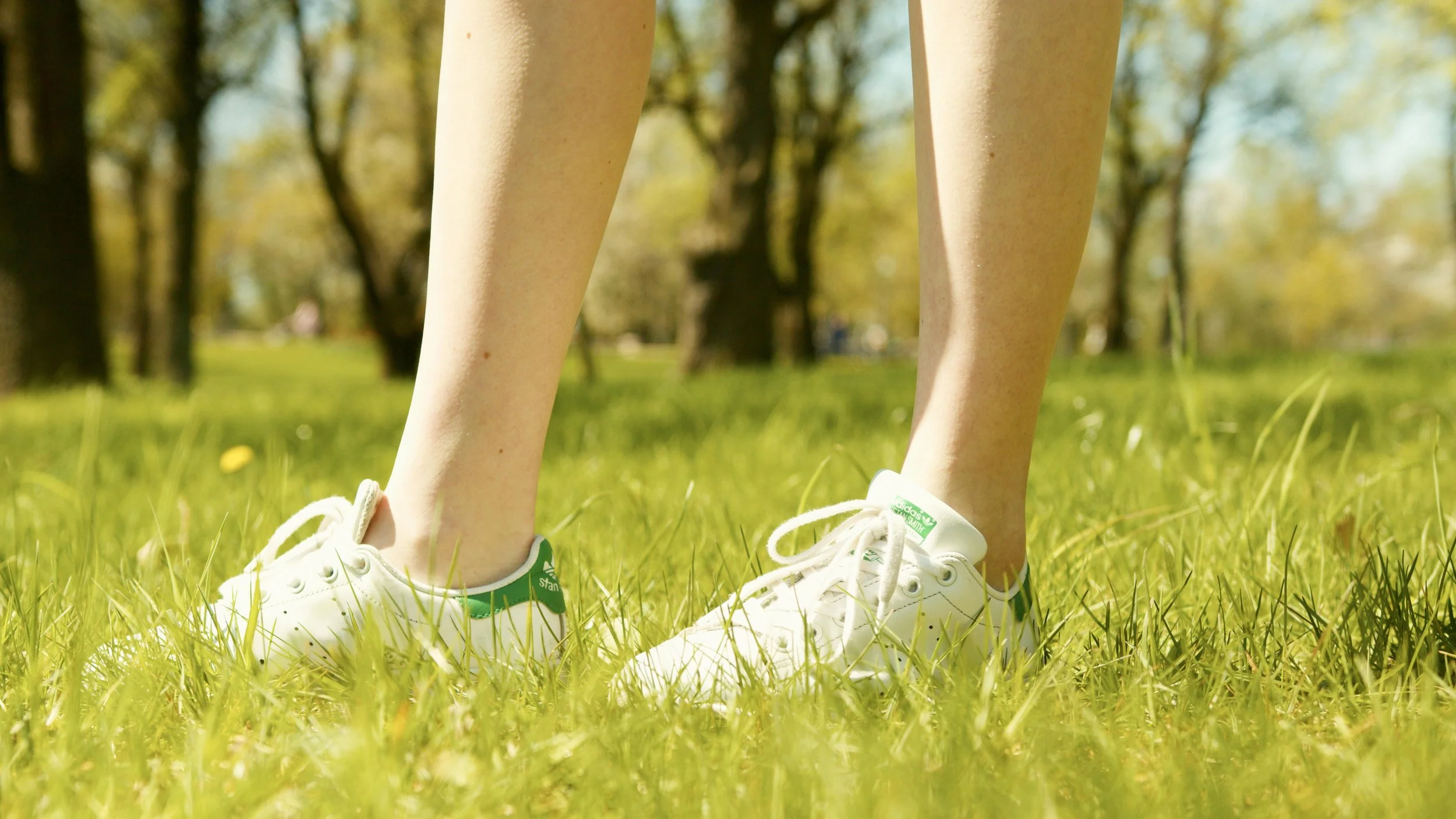 Two shoes in the grass during a walk and talk therapy session.