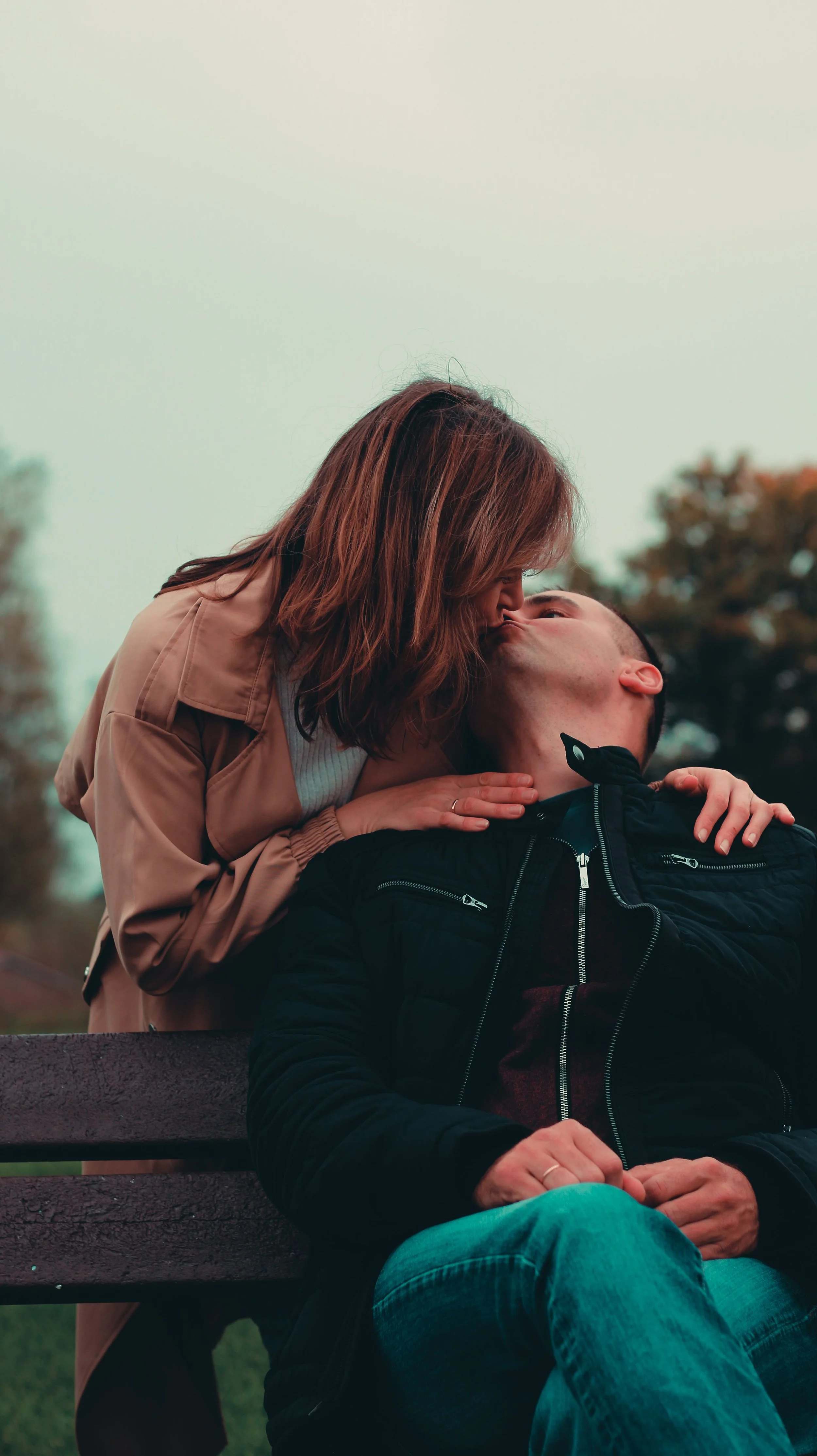 A couple on a park bench, demonstrating a connected, safe, and secure relationship.