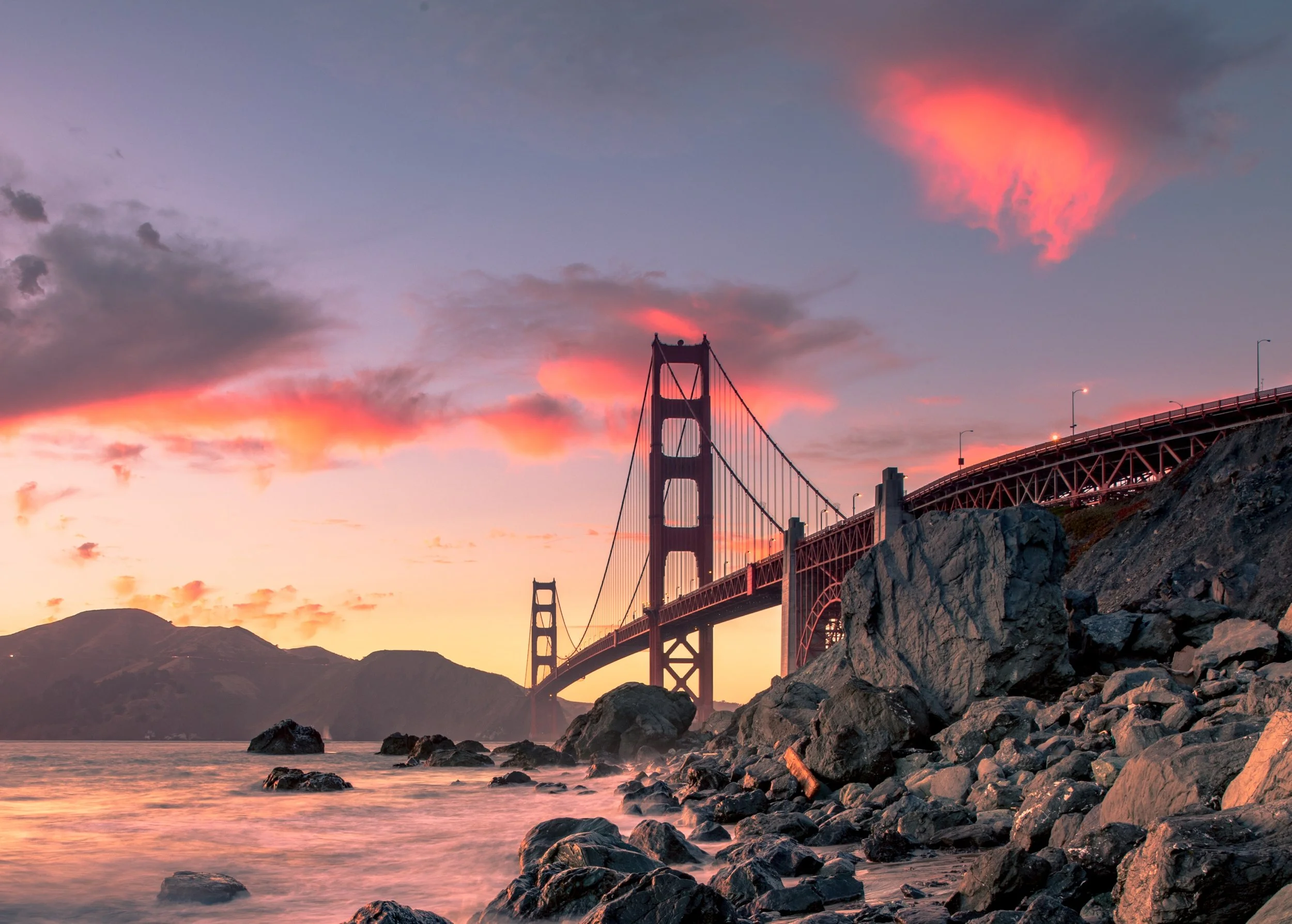 golden gate bridge with a sunset background