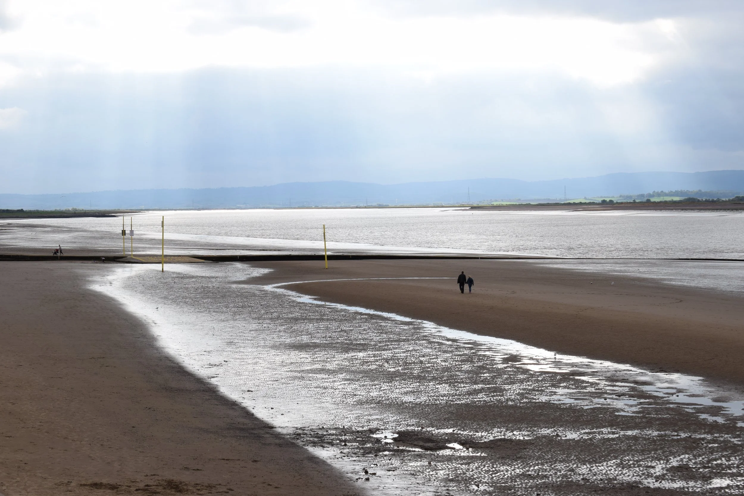 beach with sun glistening through clouds