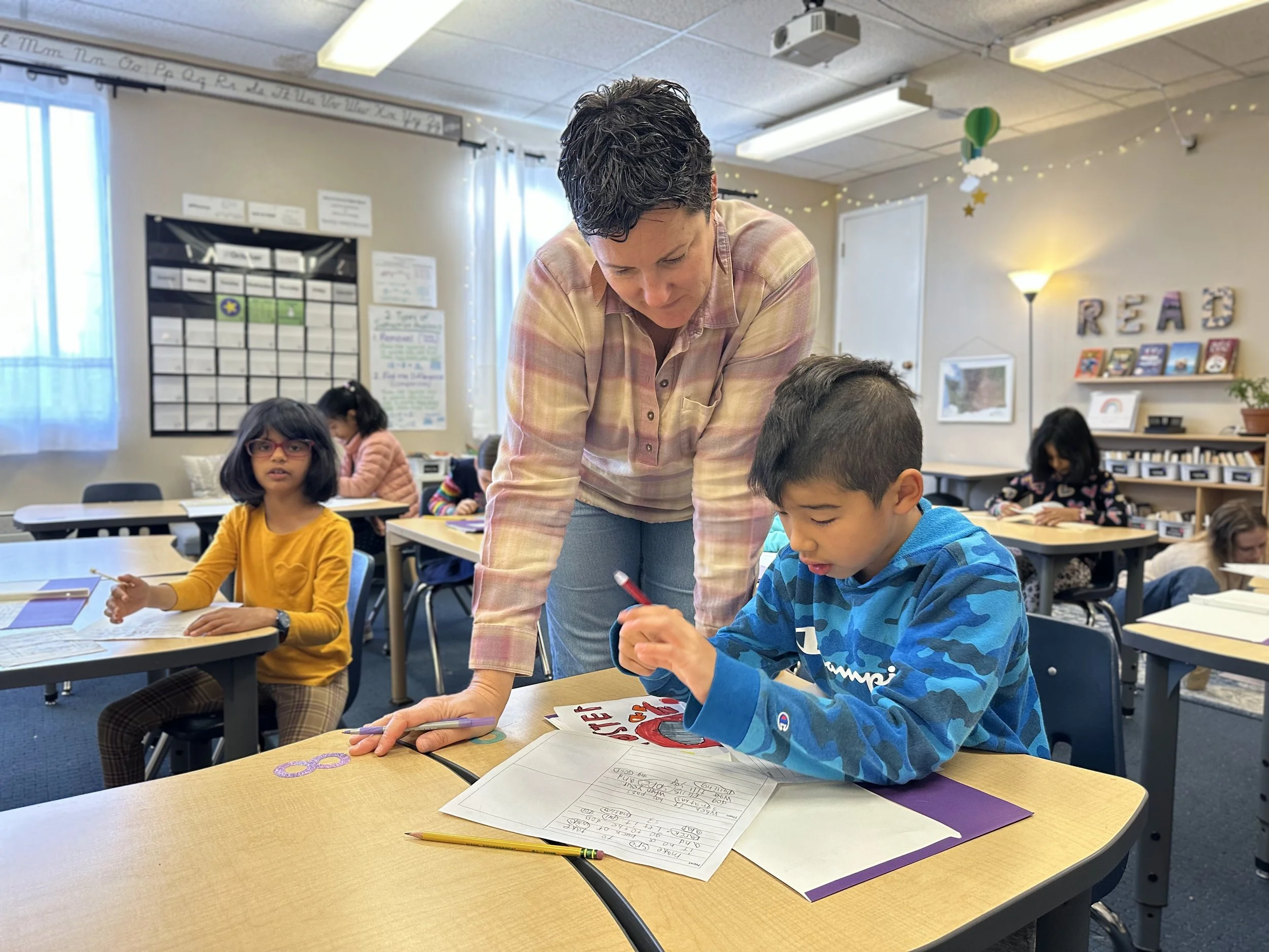 Julie helps a student