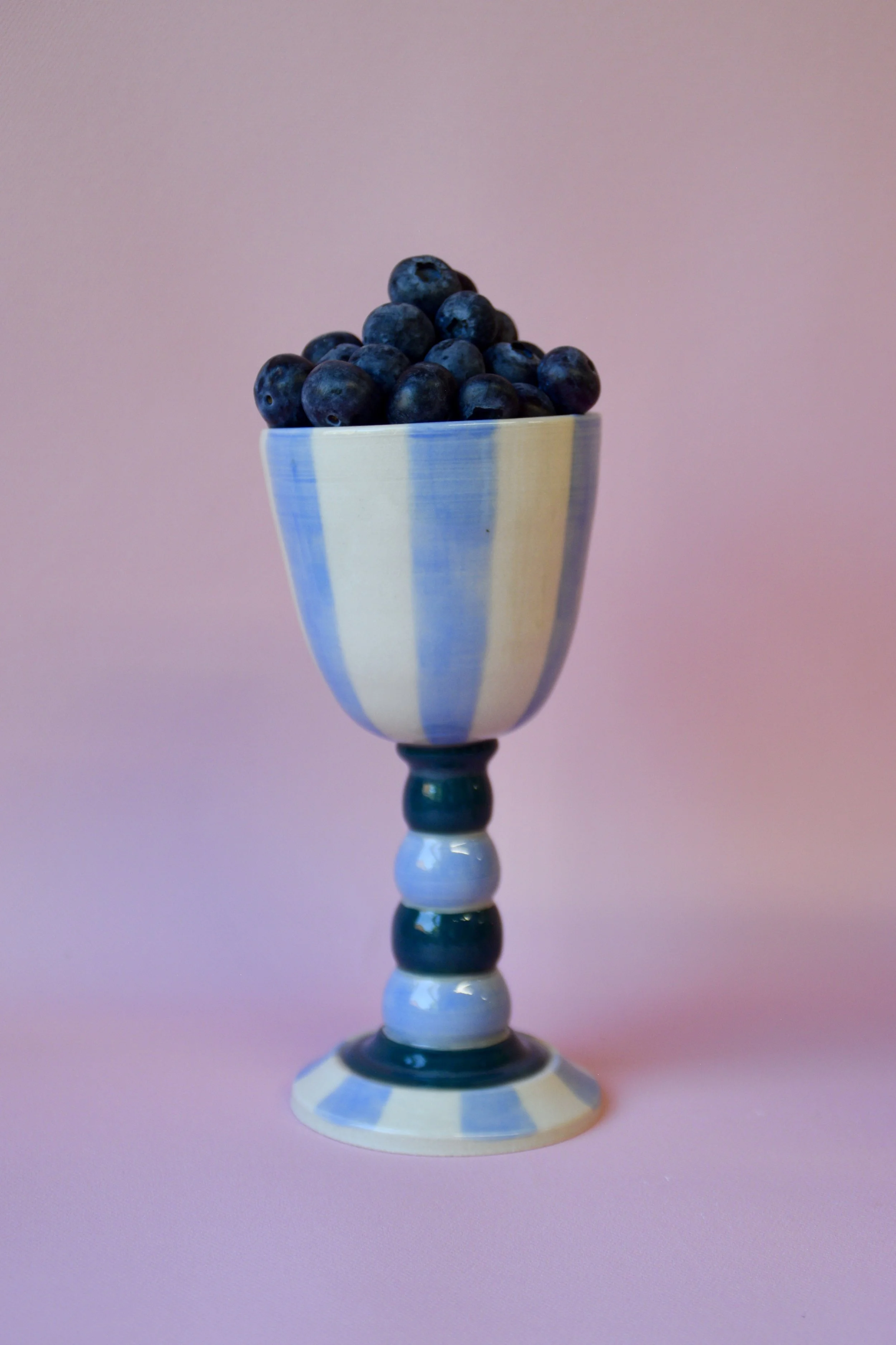 Blue striped ceramic goblet with blueberries
