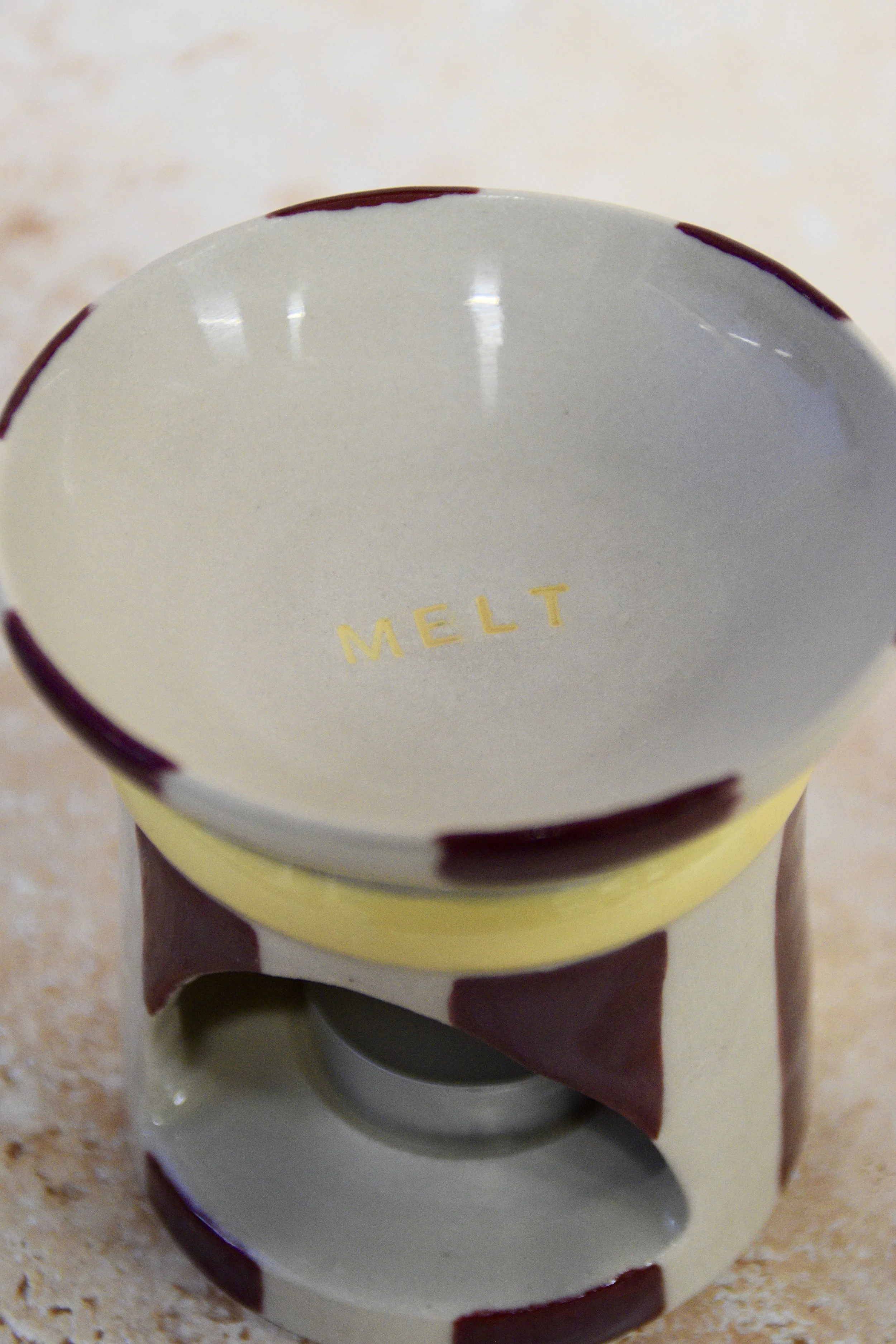 Burgundy and yellow ceramic wax burner with MELT detail