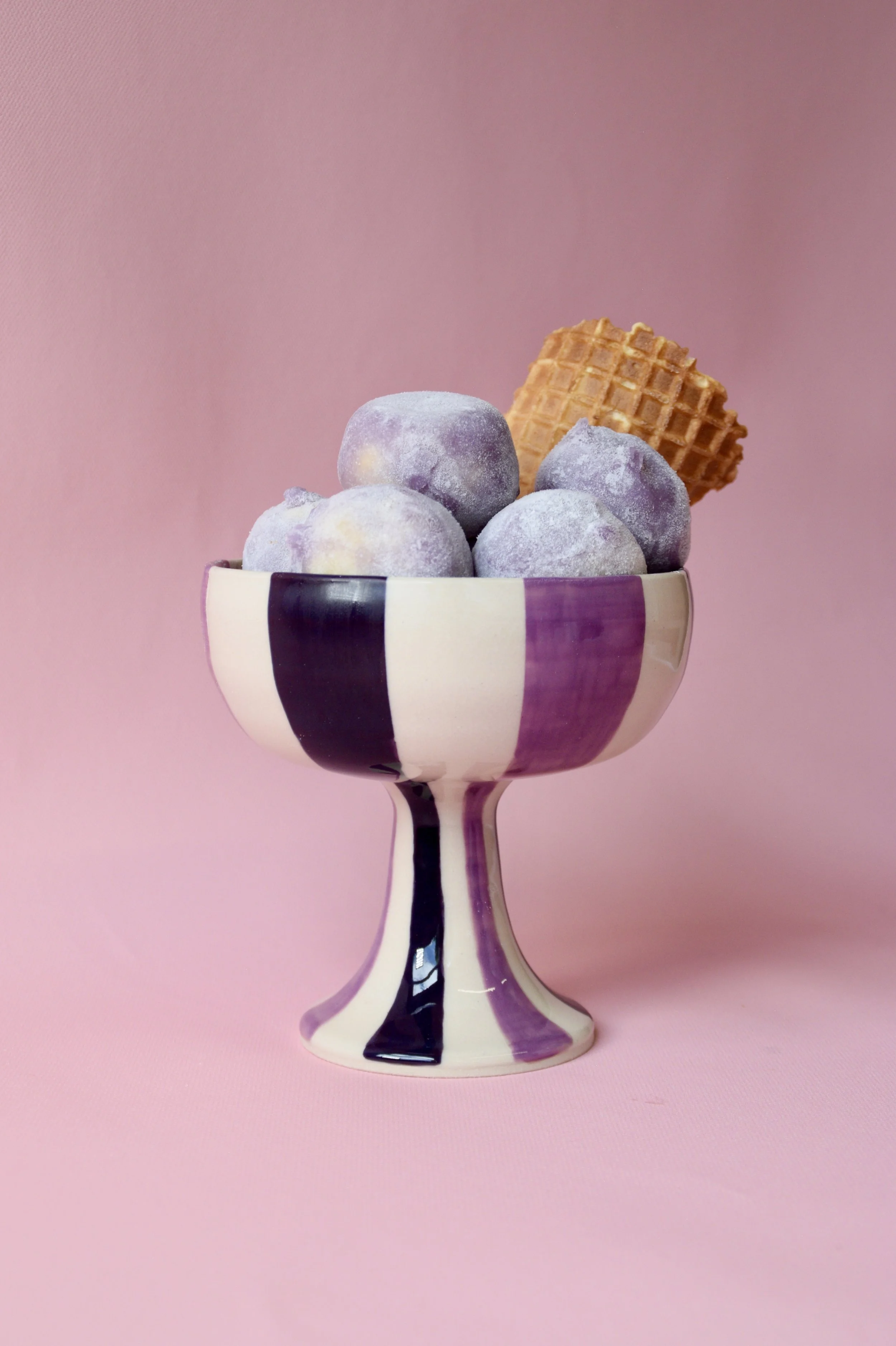 Purple striped ceramic dessert bowl with sweet treats