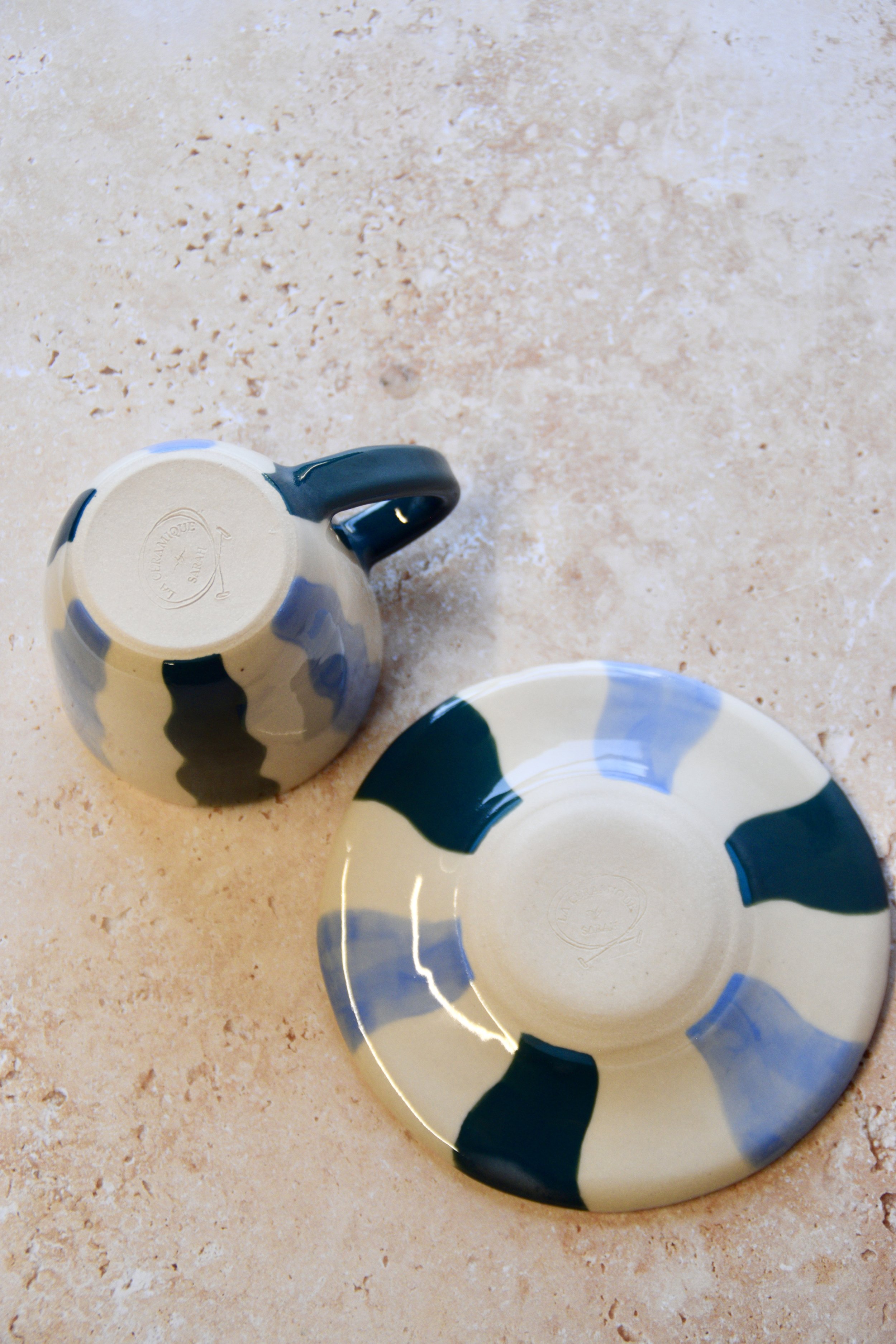 Bottom view of blue handmade ceramic cup and saucer showing base and craftsmanship.