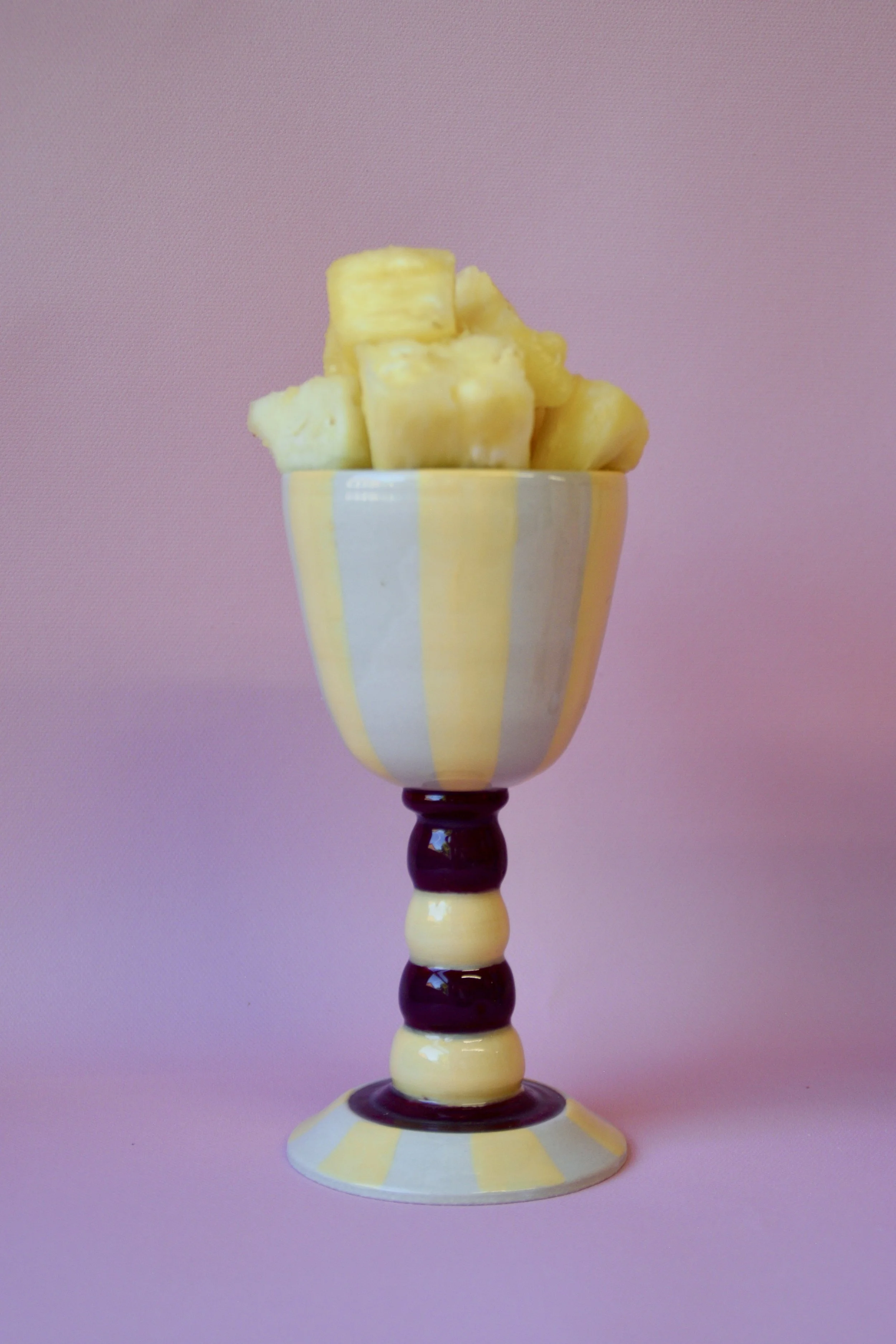 Yellow striped ceramic goblet with pineapple