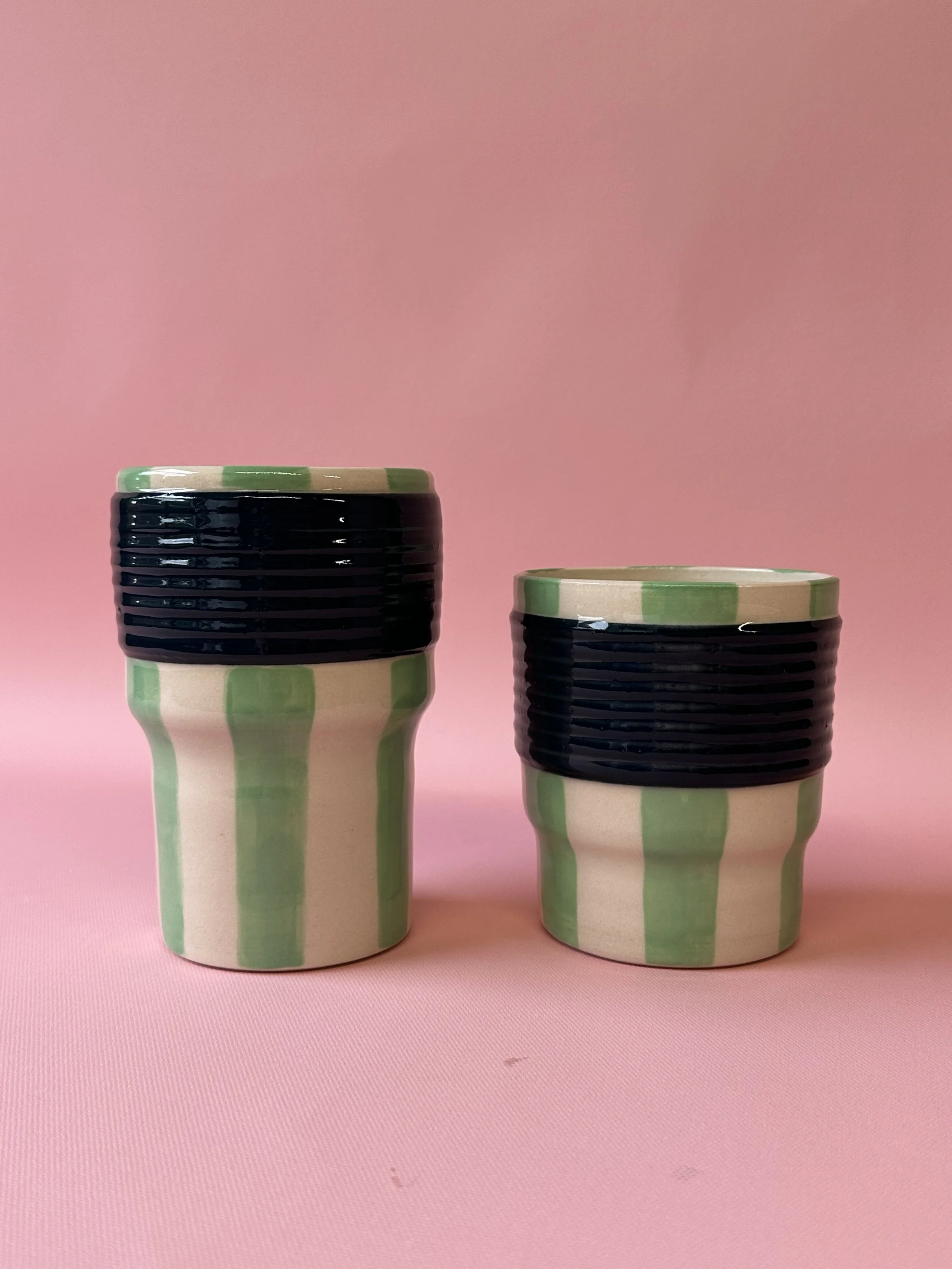 Large and small green striped ceramic tumblers