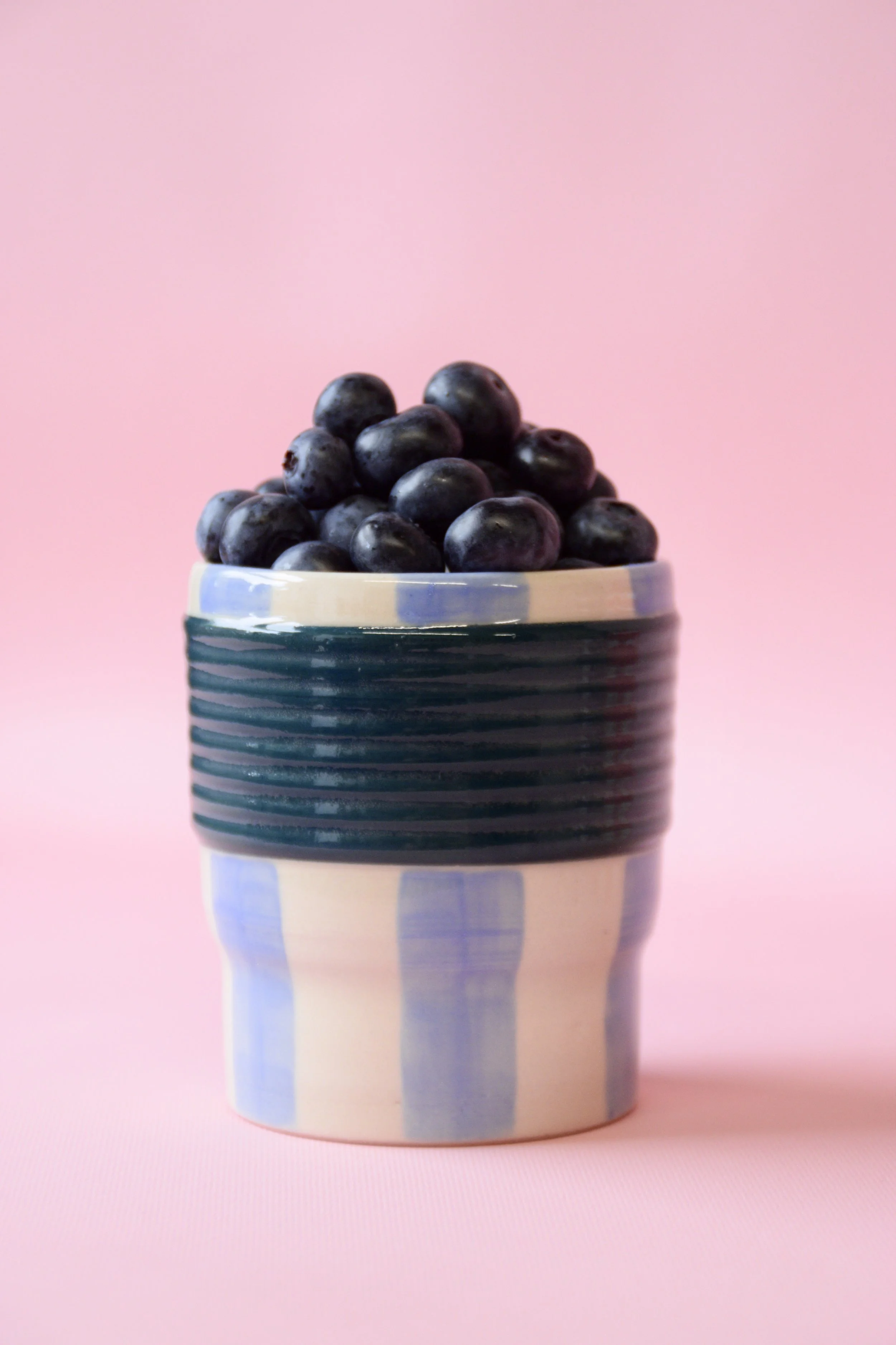 Blue striped ceramic tumbler with blueberries