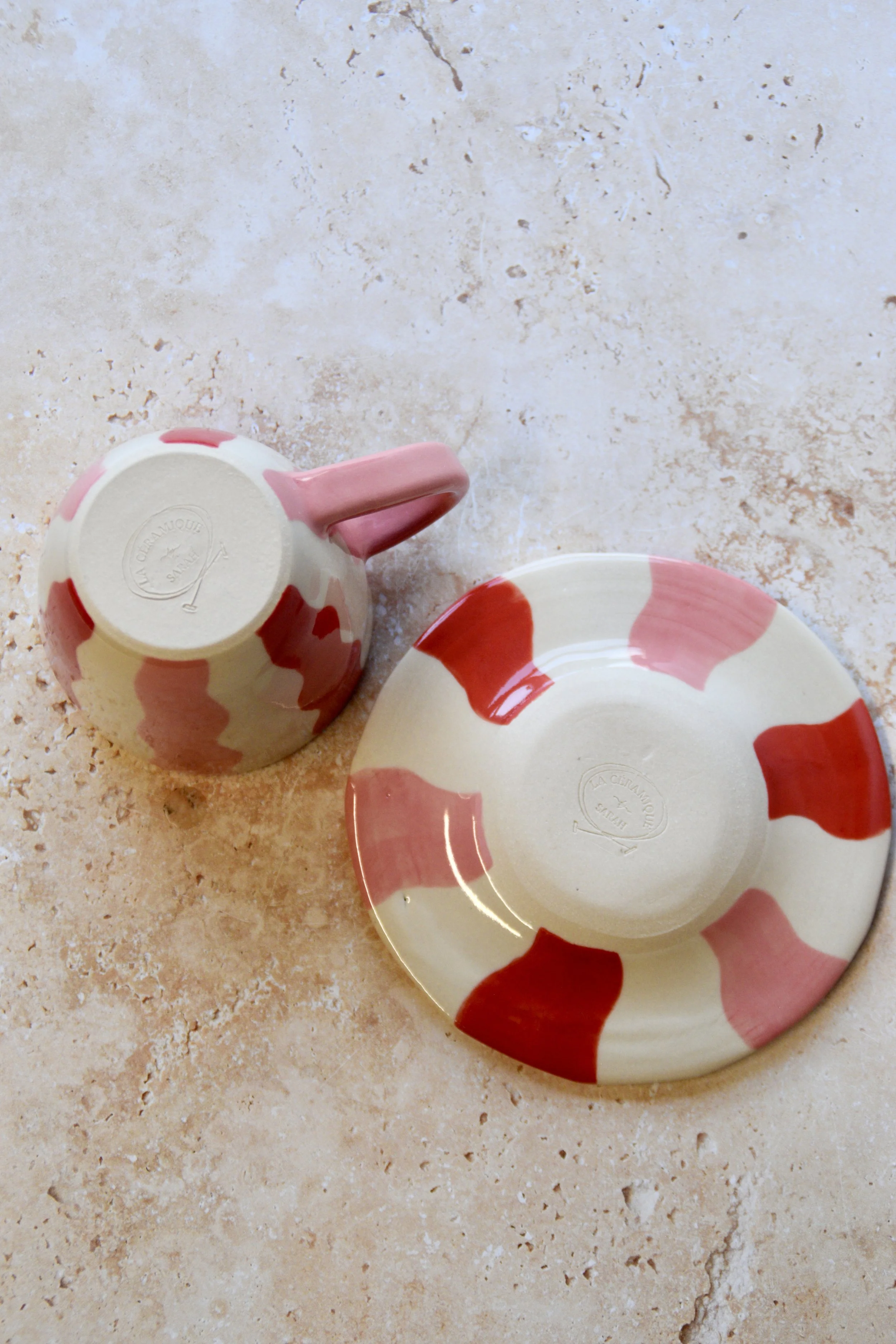 Bottom view of handmade ceramic cup and saucer showing the base and pottery finish.