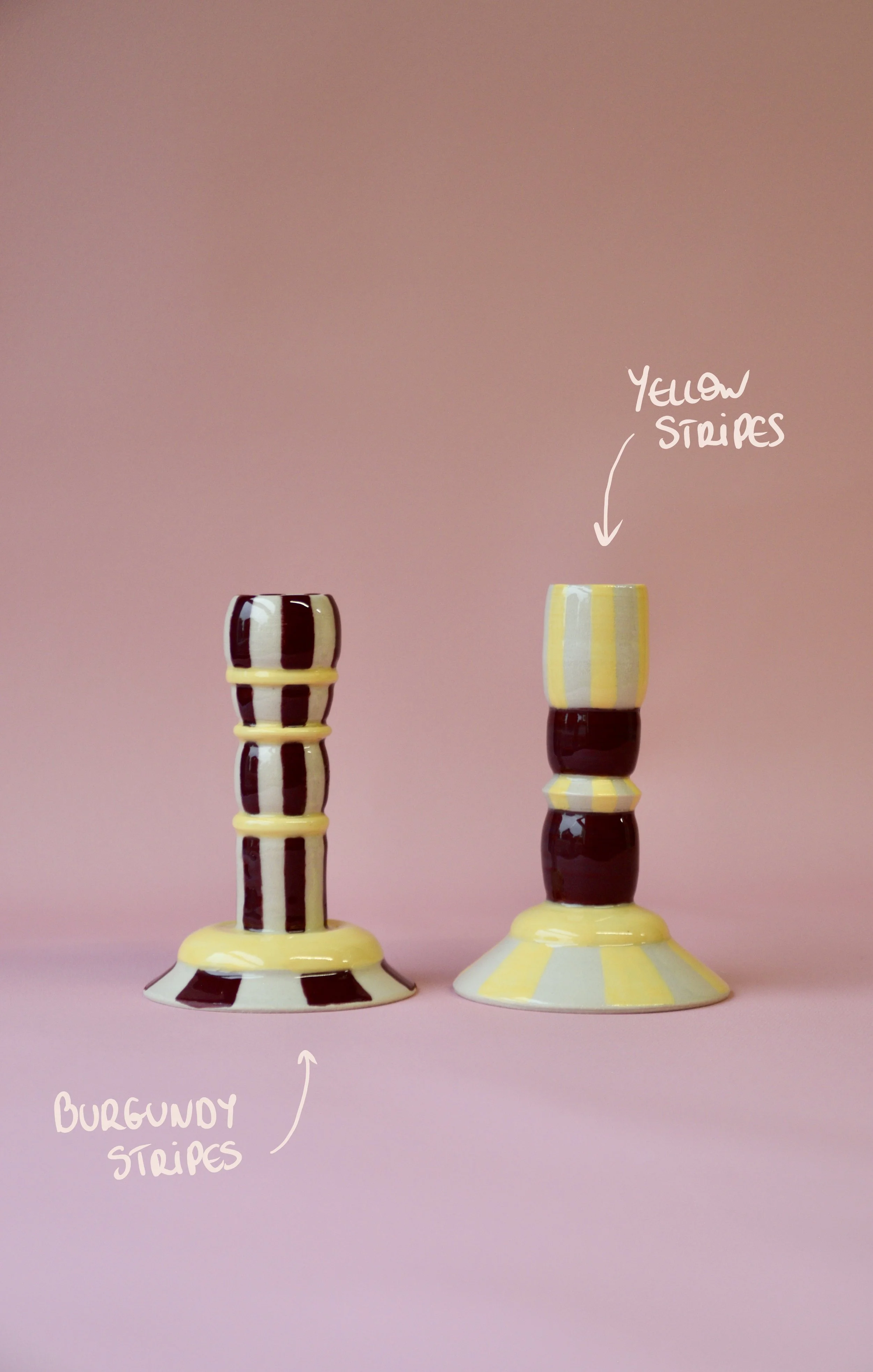 Burgundy and yellow striped ceramic candlestick holders