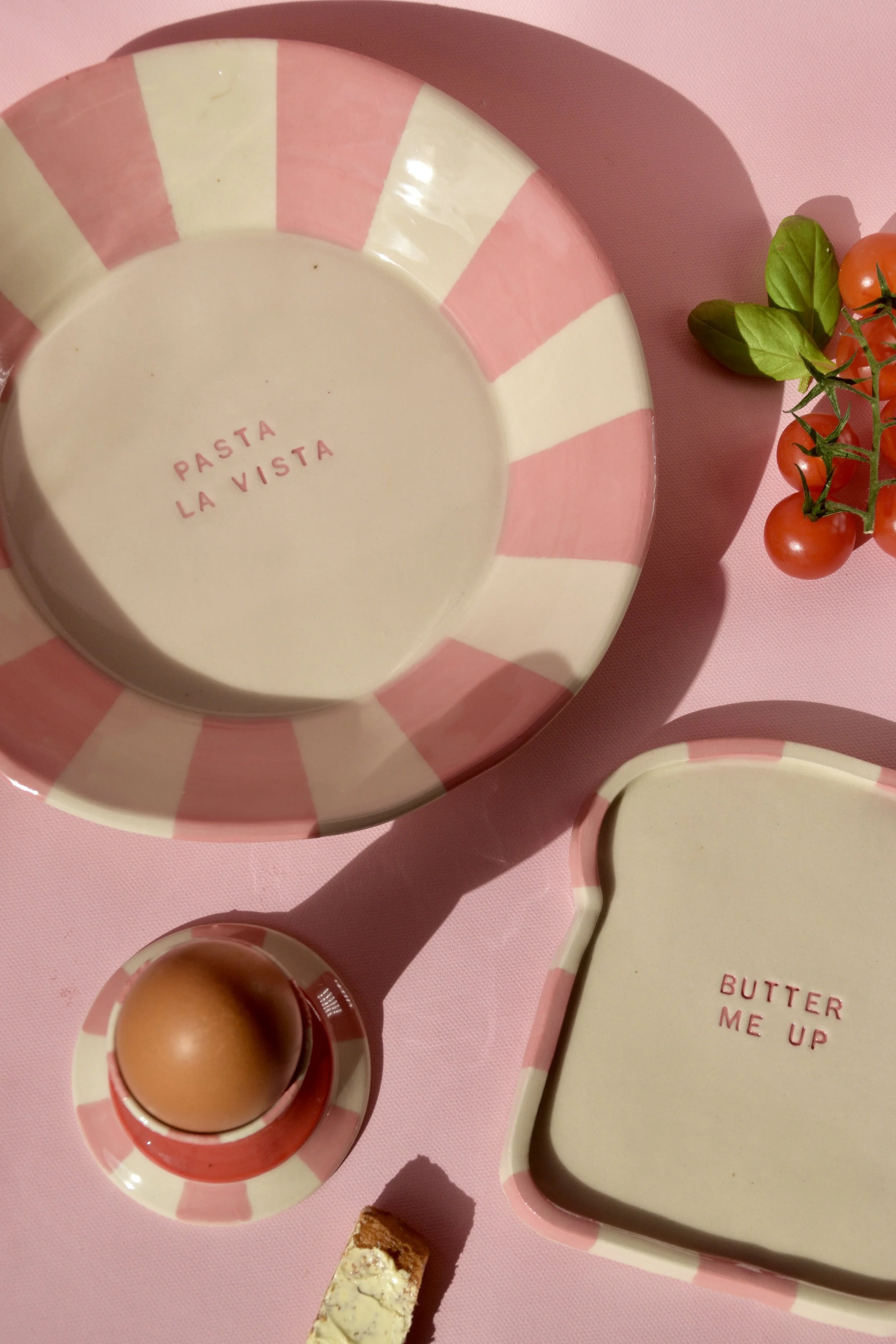 Handmade striped ceramic tableware showing stamped details