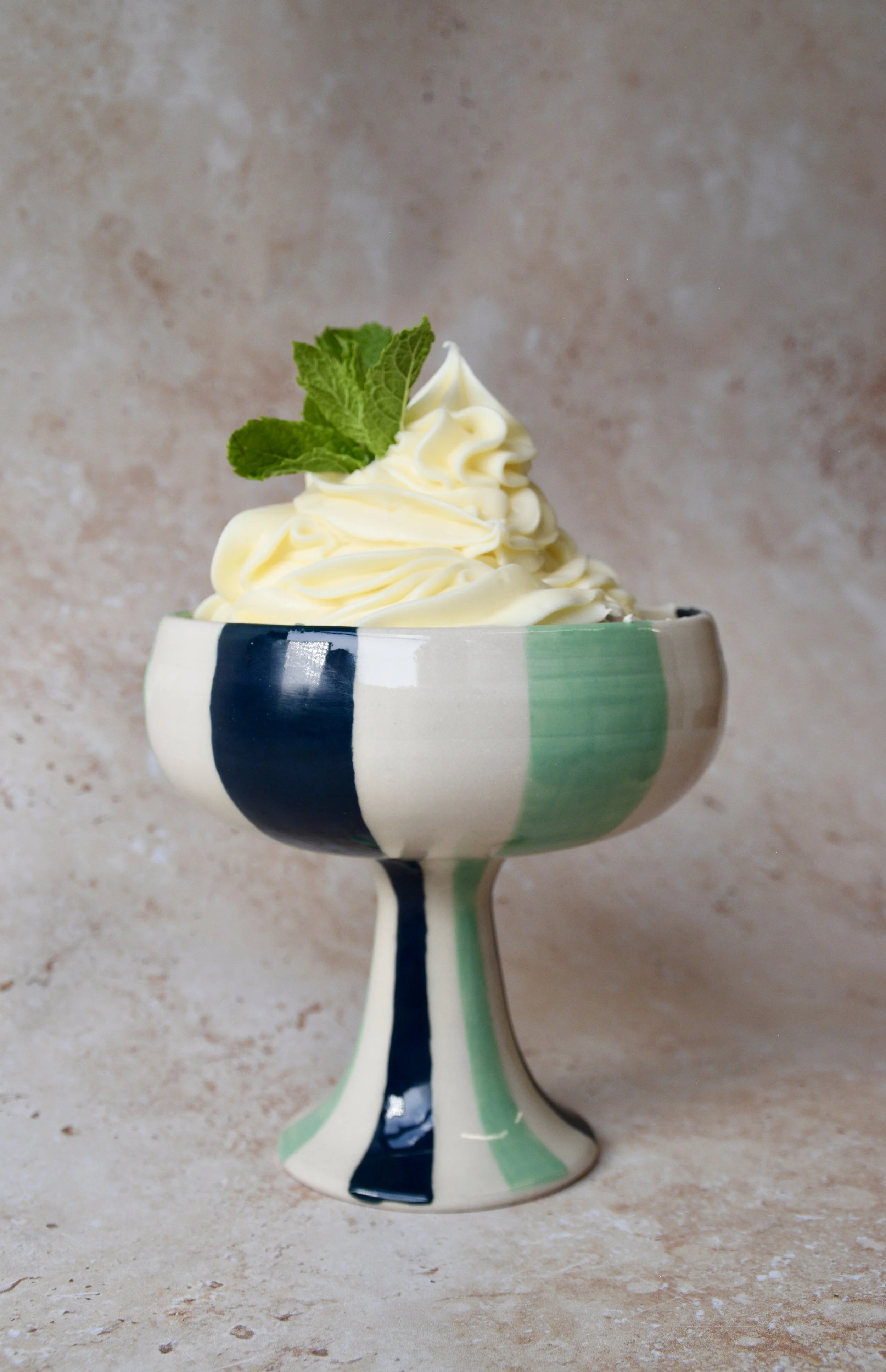 Green striped ceramic dessert bowl with ice cream