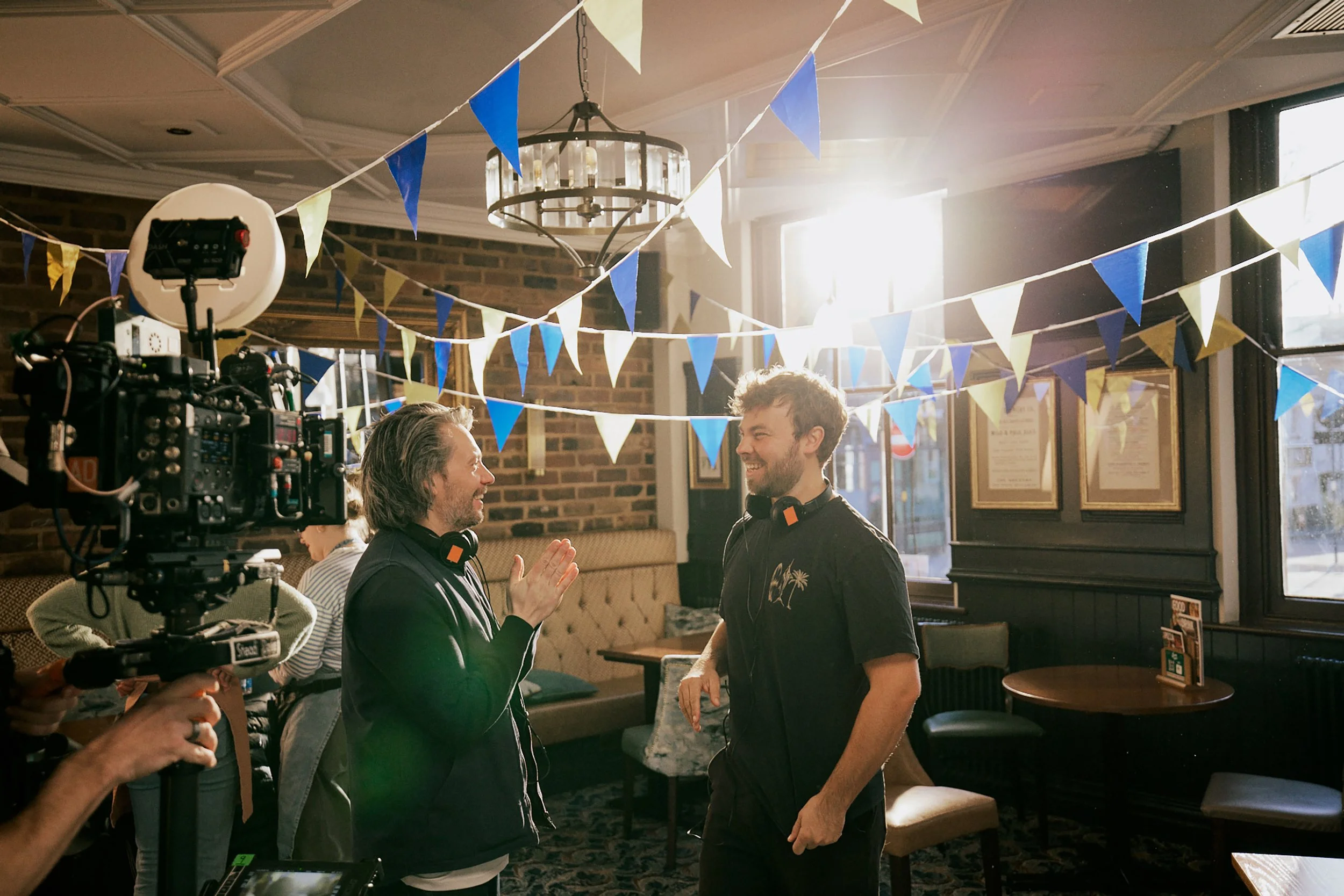 Sam Palmano of Opposite Land Productions video production company talking to a member of his team on an F&B shoot