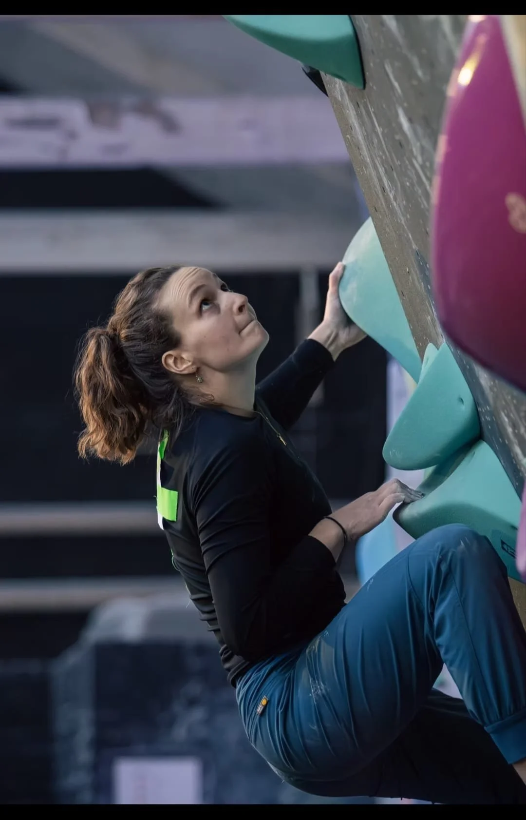Ciara Whyte MSc Physiotherapist climbing an indoor climbing wall