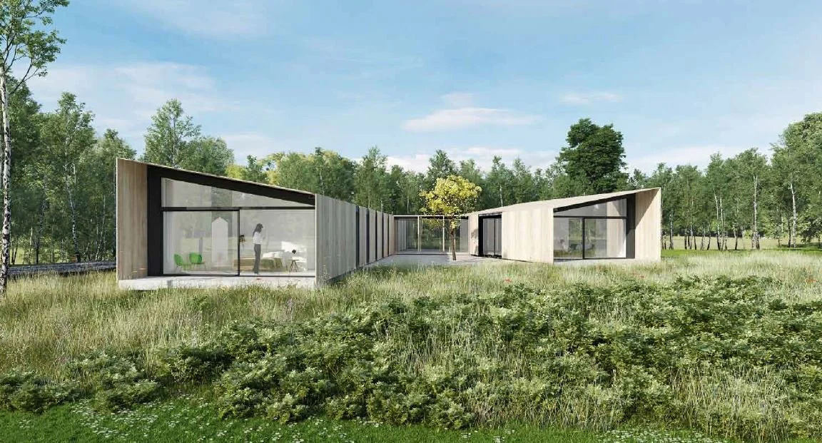 Modern house with angular design and large glass windows, surrounded by a grassy field and trees under a blue sky.