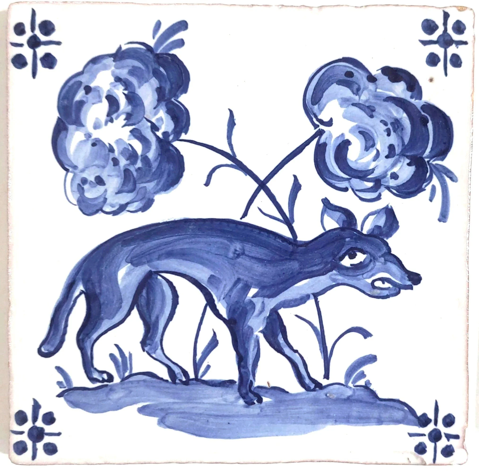 Blue and white ceramic tile featuring a donkey with a long neck, standing on ground, with two large flowers and floral patterns in the top corners.