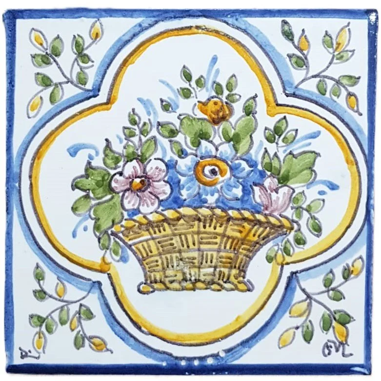 A decorative plate with a floral design, featuring a basket of pink and purple flowers with green leaves, enclosed in a yellow and blue border.