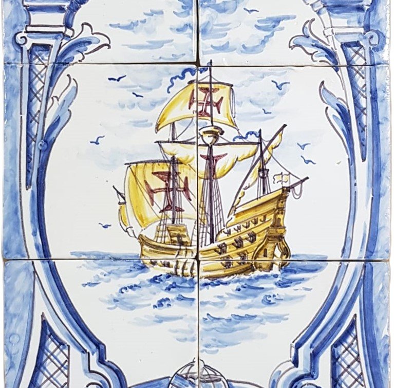 Painted ceramic tiles depicting a historic sailing ship with yellow sails on the ocean, framed by decorative blue and white architectural elements.