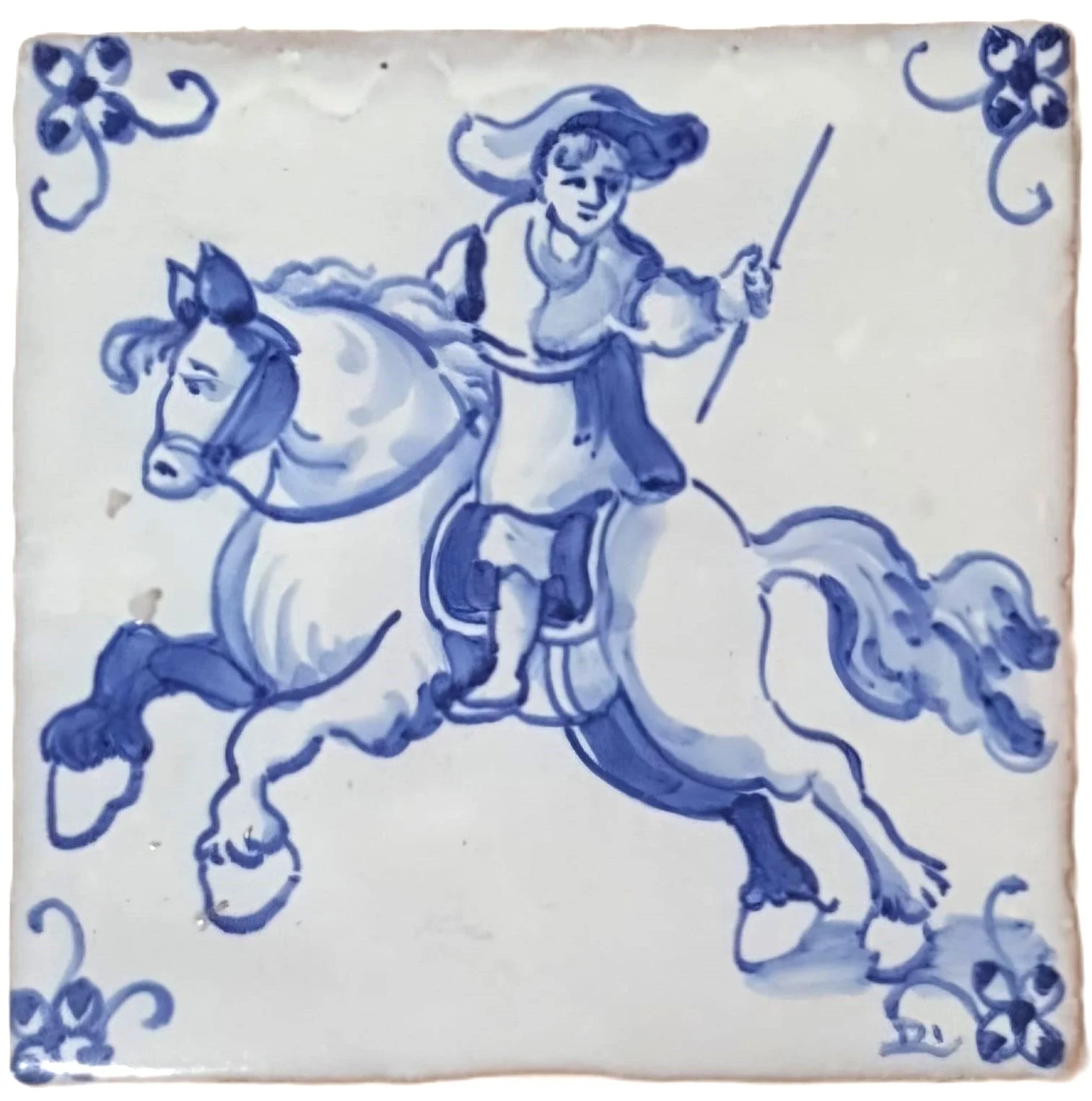 Blue and white ceramic tile featuring a hand-painted illustration of a person riding a galloping horse, holding a lance, with decorative corner patterns.