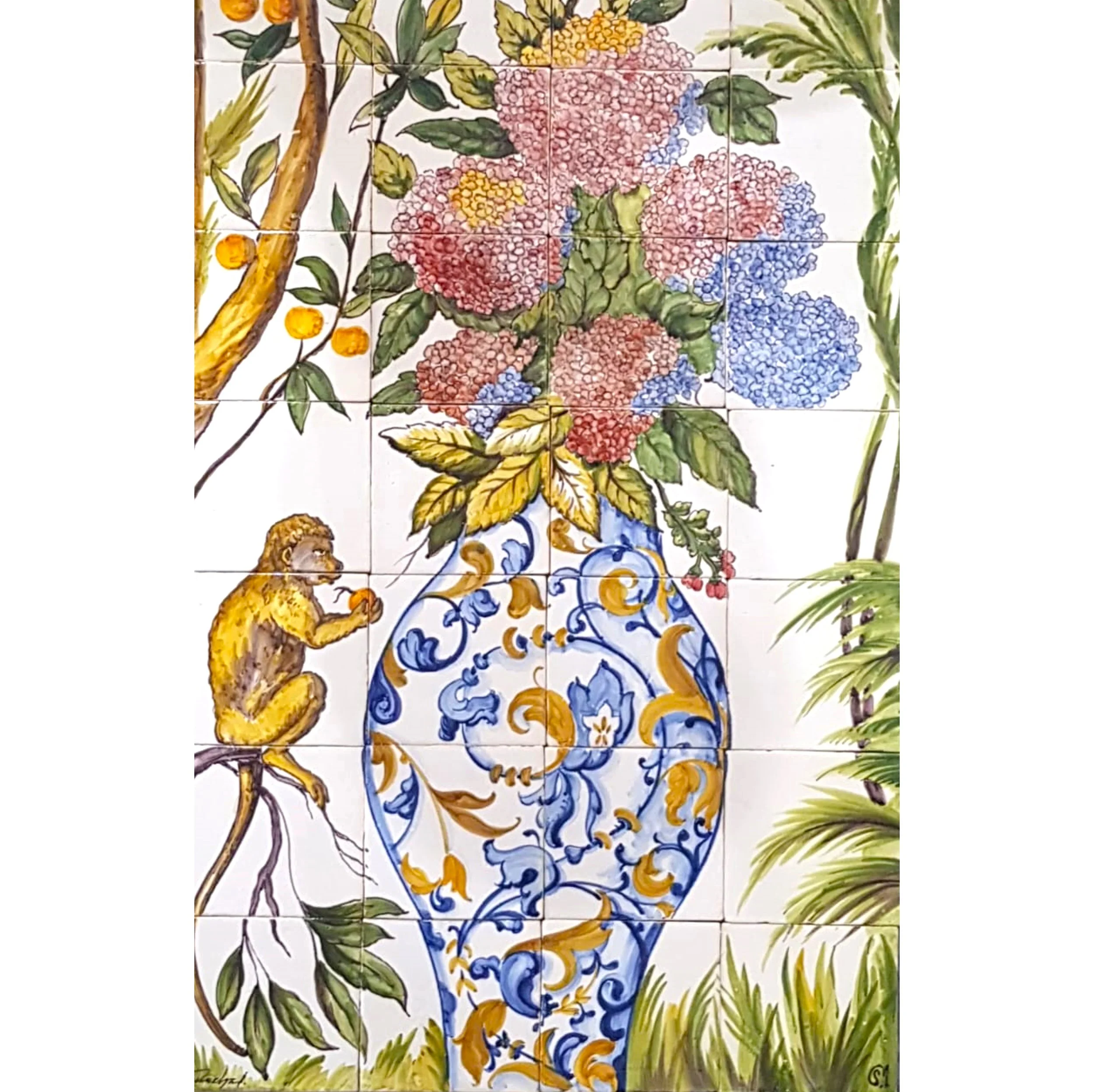 A decorative tile wall featuring a large blue and yellow ornate vase holding a bouquet of pink, purple, and blue hydrangeas. A small monkey is sitting on a branch near the vase, holding an orange fruit. Surrounding foliage includes green leaves, with a yellow-orange branch on the left. The style is colorful and detailed, resembling hand-painted ceramic art.