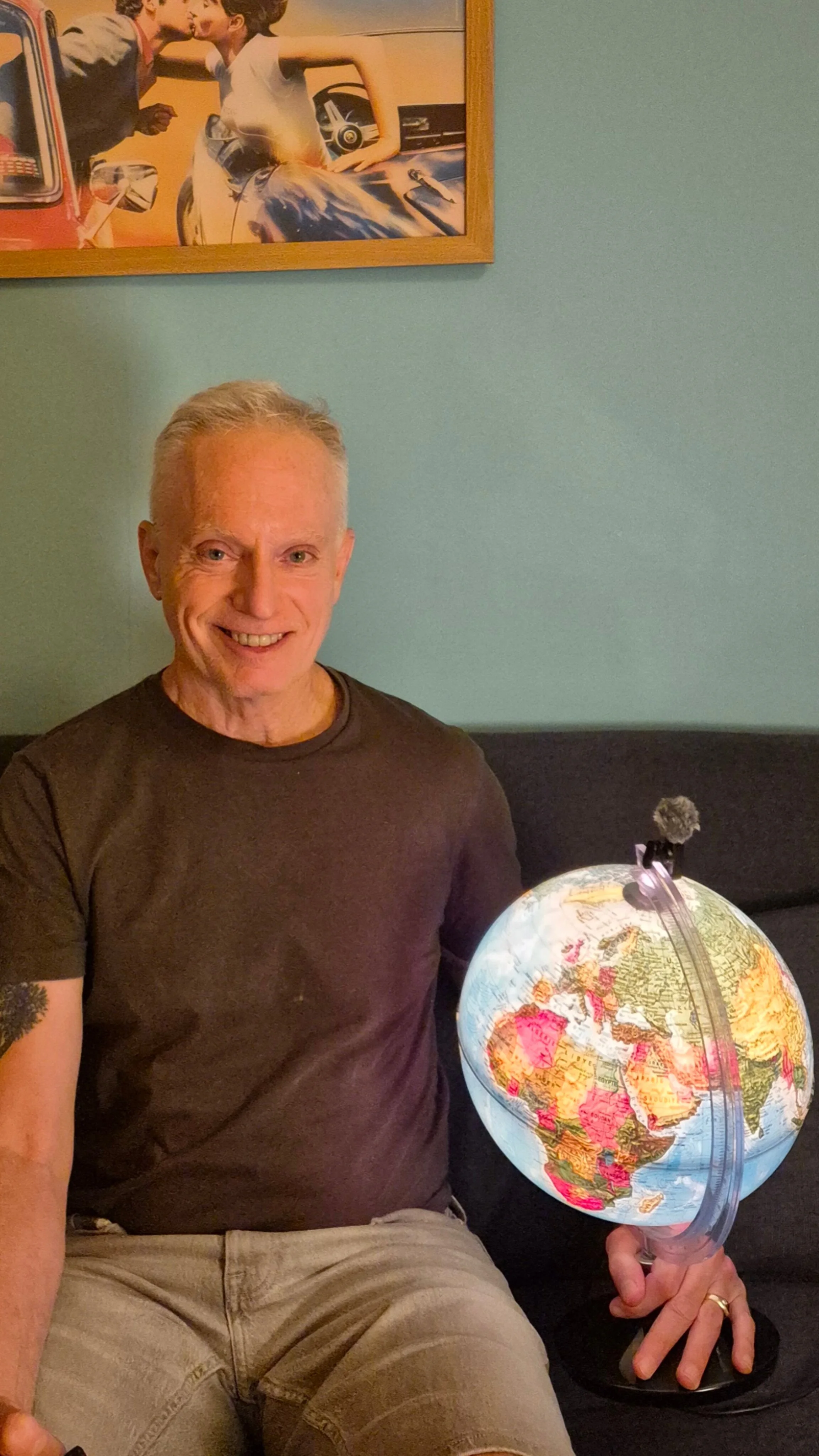 Michael Huffman, The Zen Guy, holding a world globe while planning a France relocation scouting trip